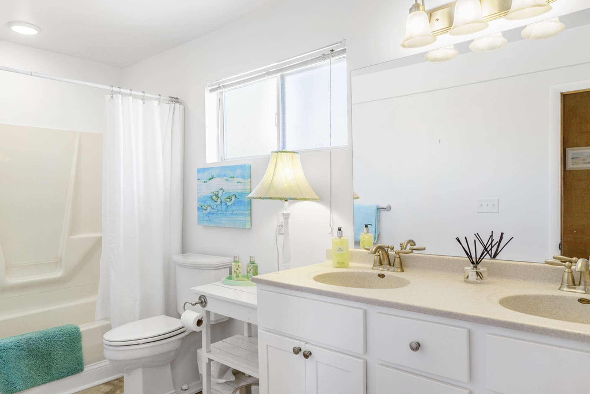 A spacious bathroom designed to comfortably host up to five guests.