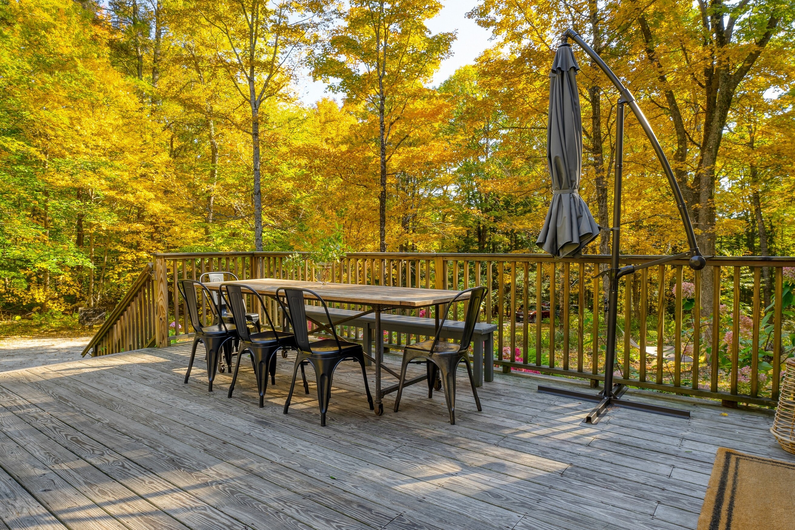 Large outdoor dining table is the perfect place for al fresco meals among the trees.