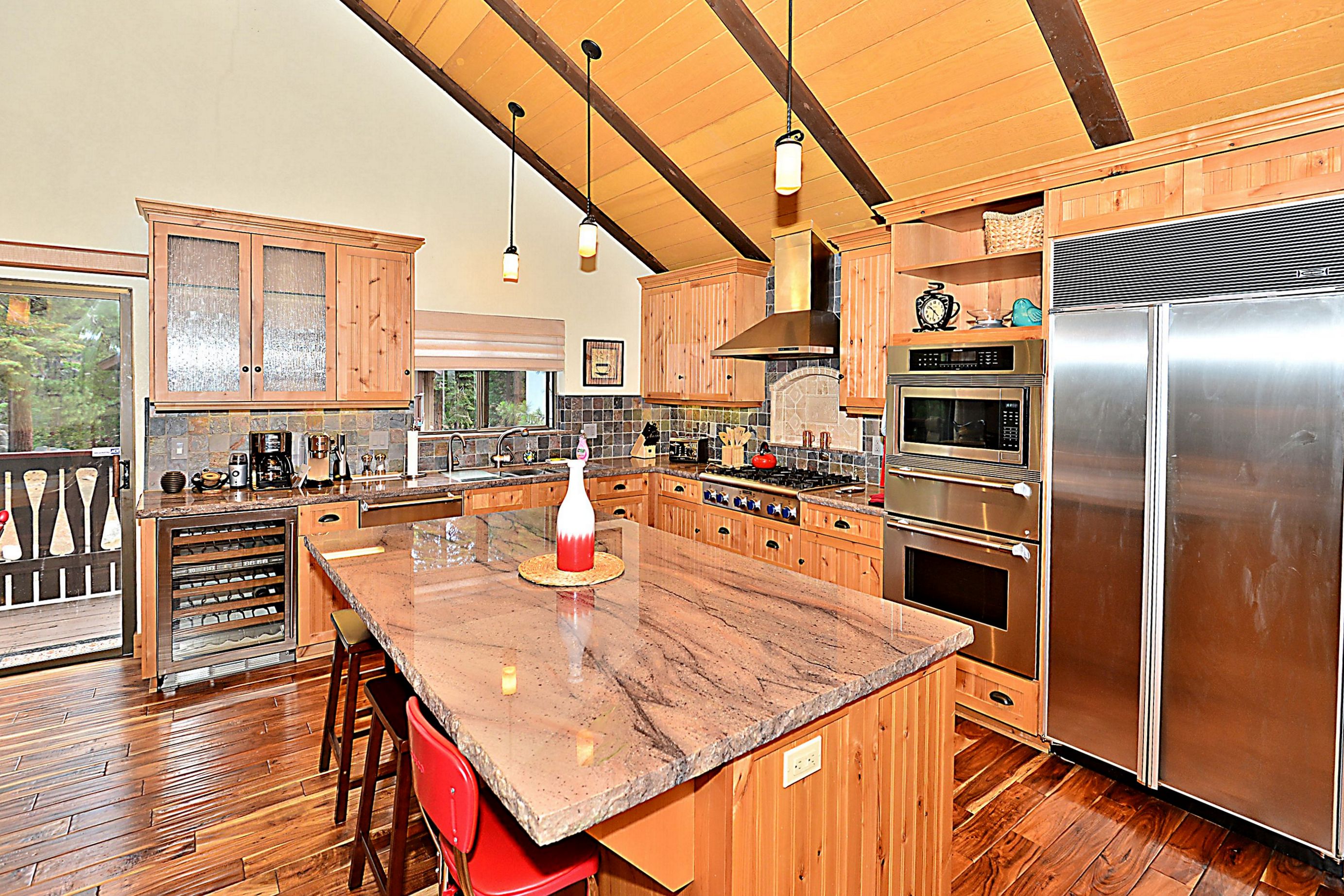 The kitchen is newly remodeled with top-of-the-line chef's appliances and a granite island.