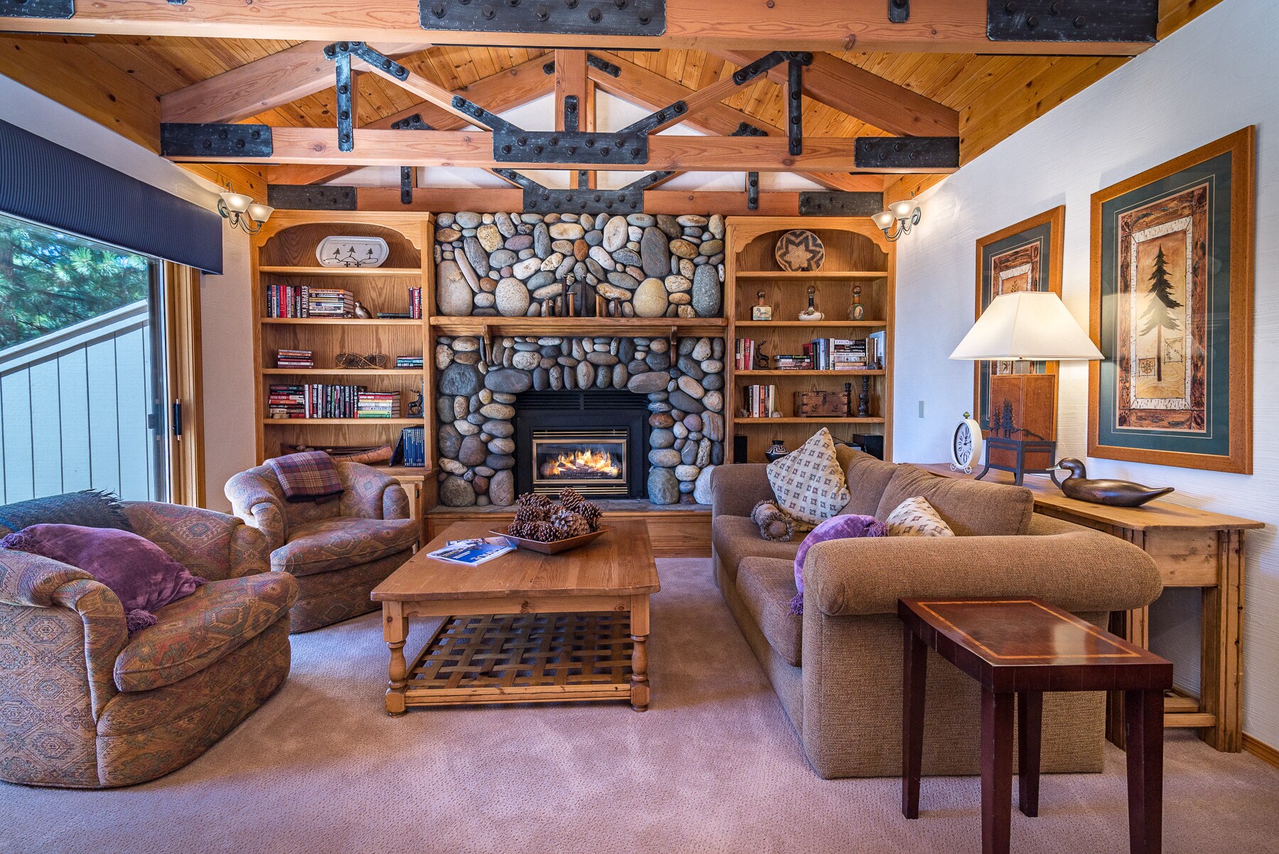 The cozy cabin-style living room invites you to snuggle up with a book.