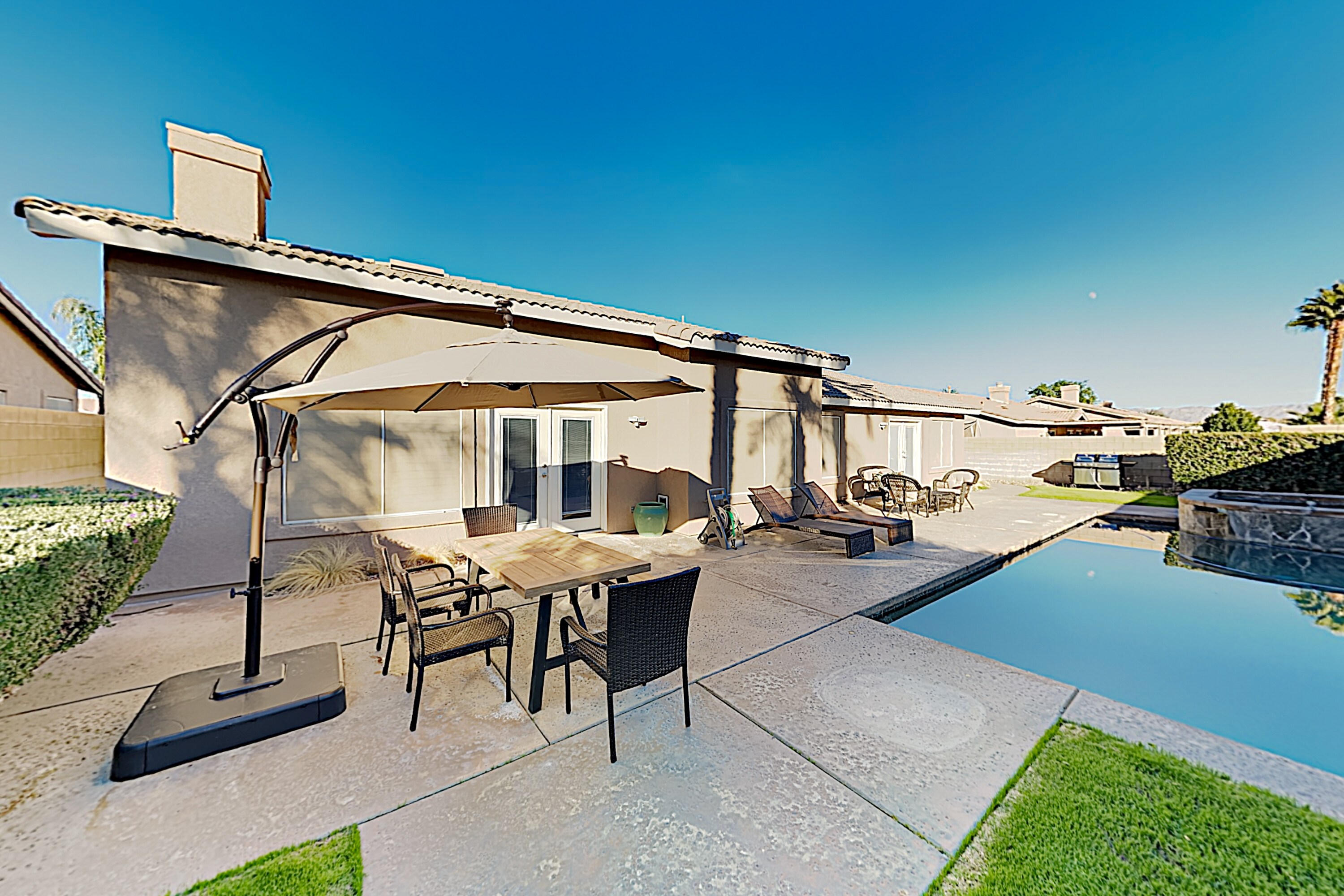 A private south-facing backyard boasts a heated saltwater pool and hot tub!