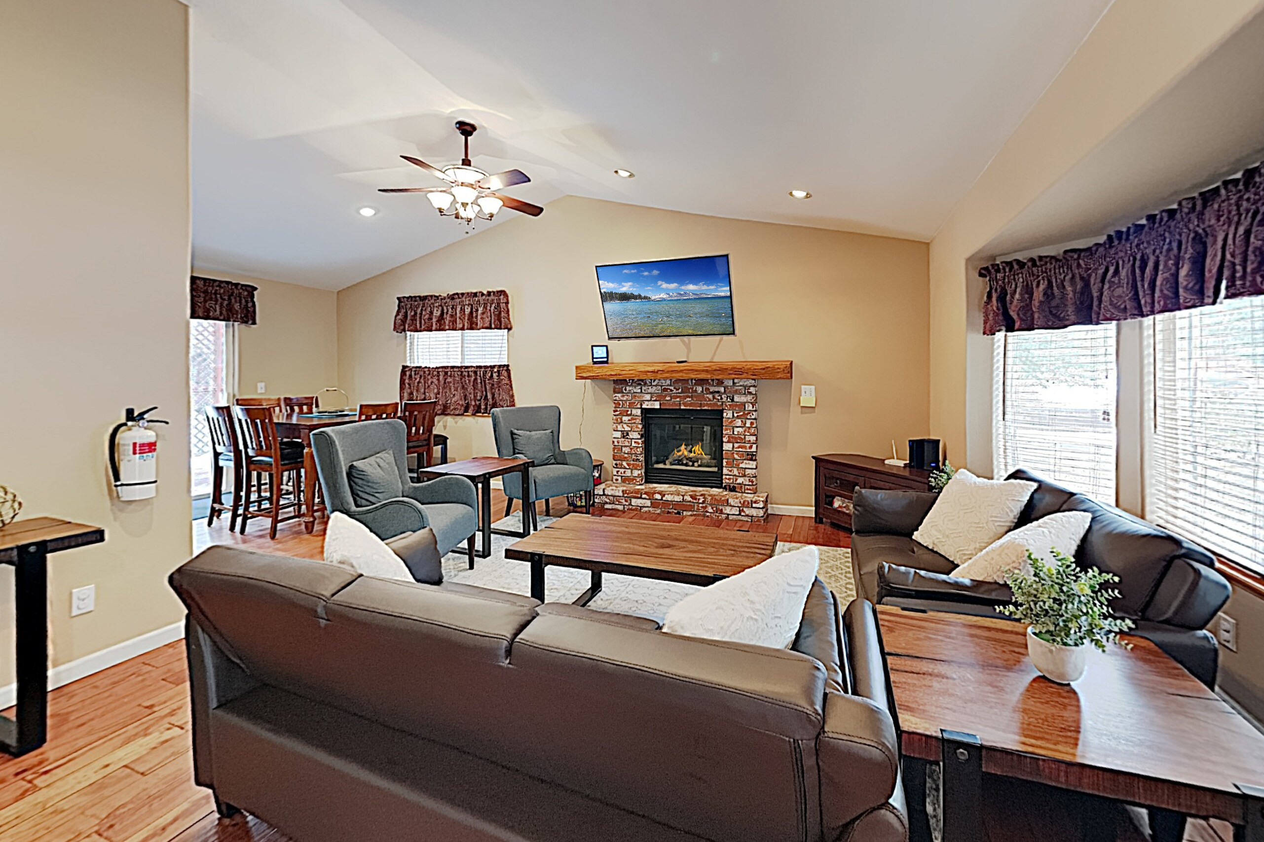 A brick-lined gas fireplace sits center stage in the light-filled living room.