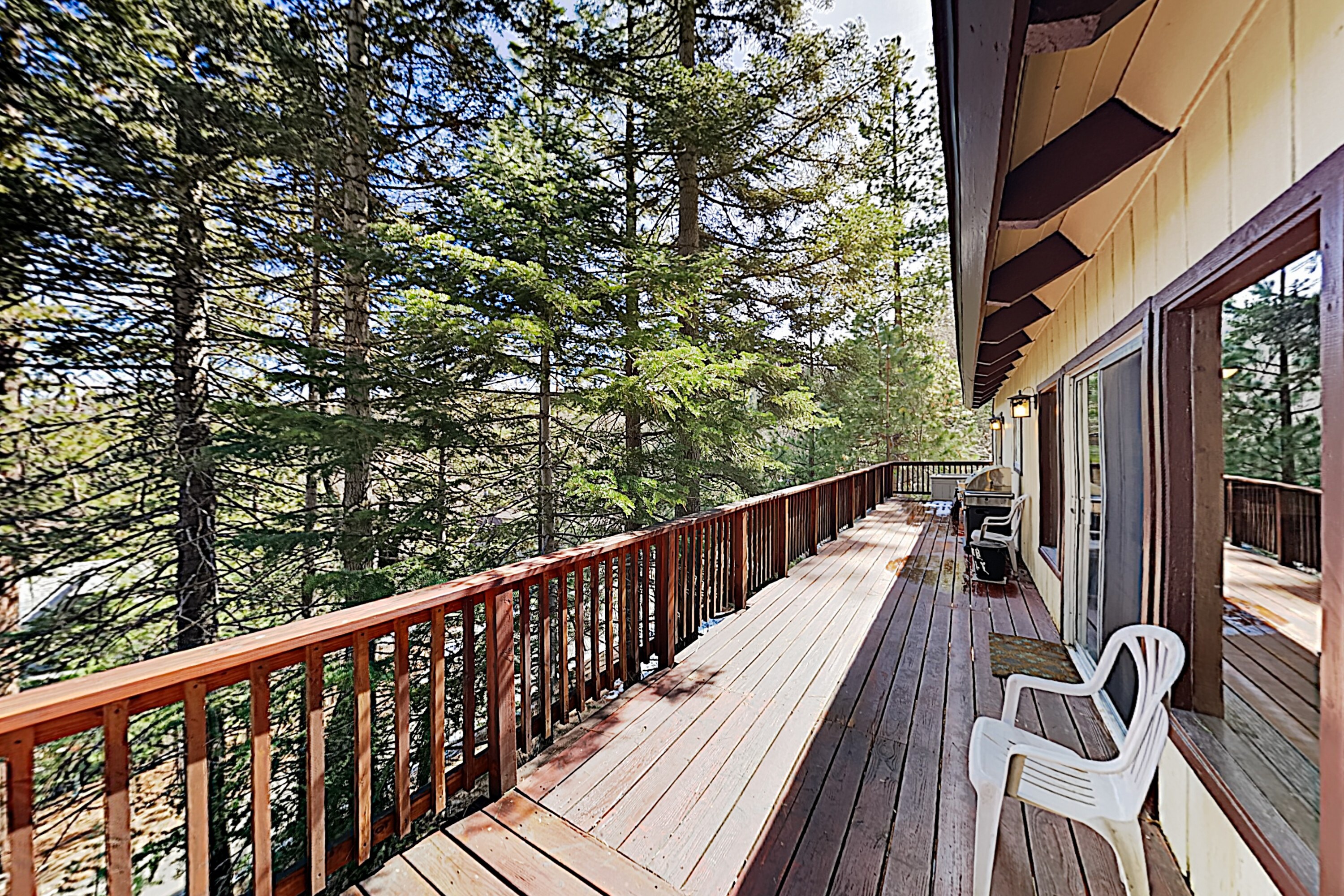Relax on the spacious deck and look out over the pine trees.