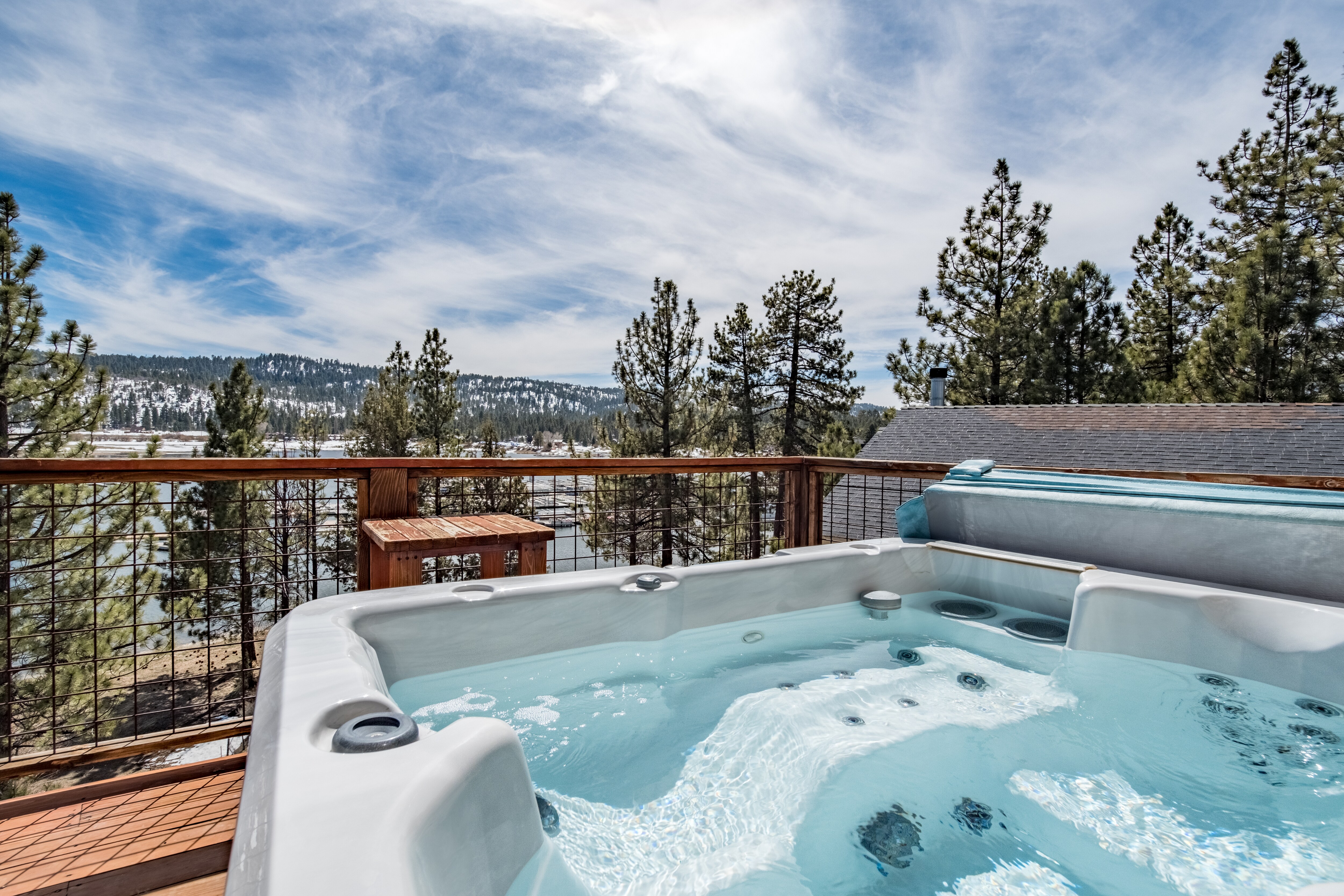 Enjoy unparalleled views of Big Bear Lake from your spacious balcony and private hot tub.