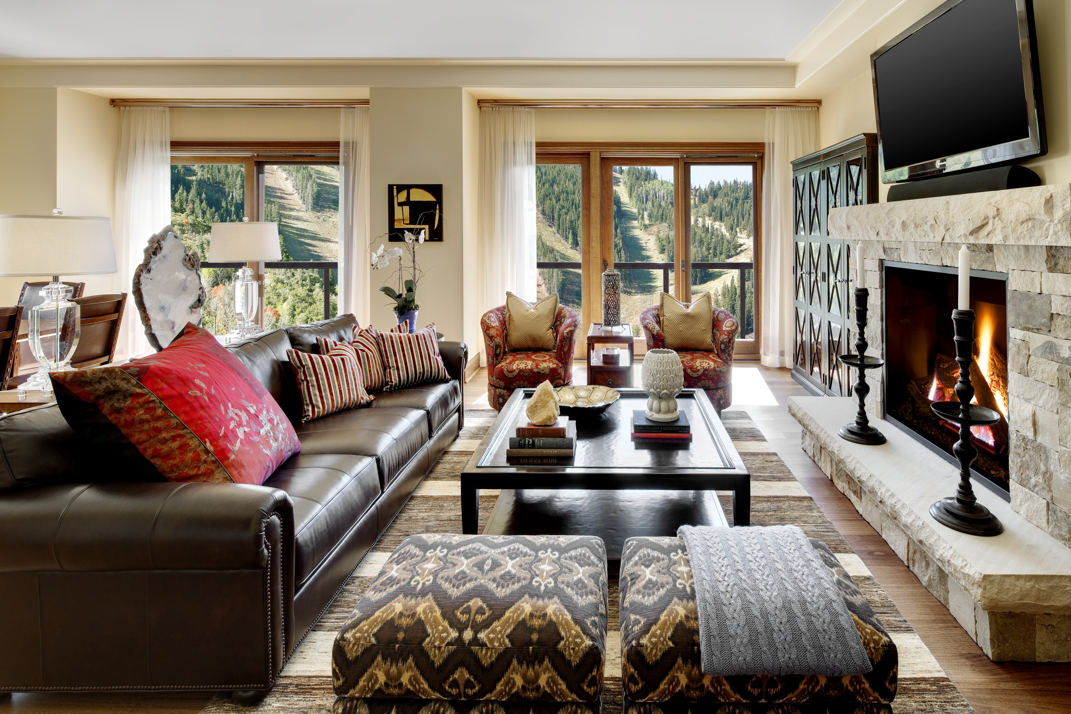 Living room with leather sofa and stone fireplace