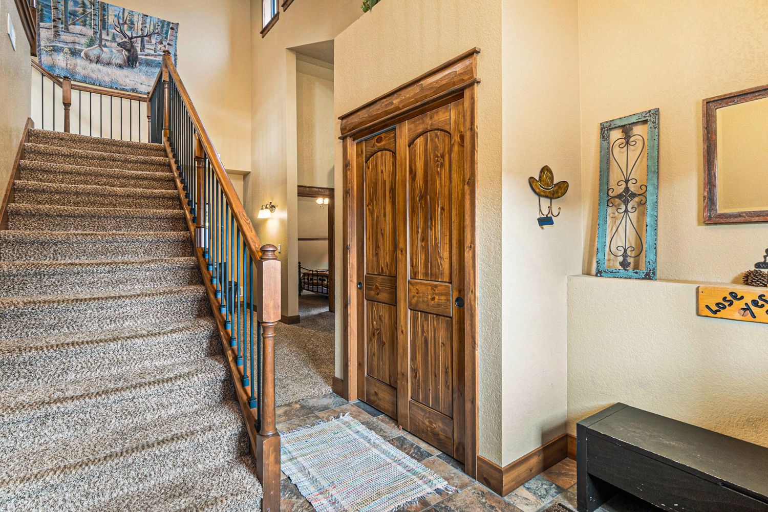 Timber Mountain Retreat - Entryway into the home, carpeted stairs up to main living/dining area.