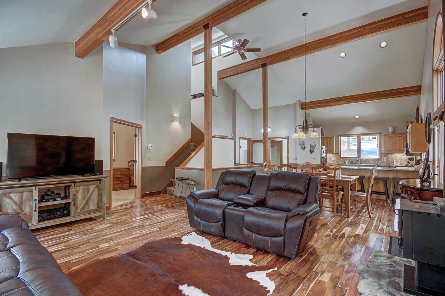 Main level living room with flat screen TV, wood burning fireplace - 