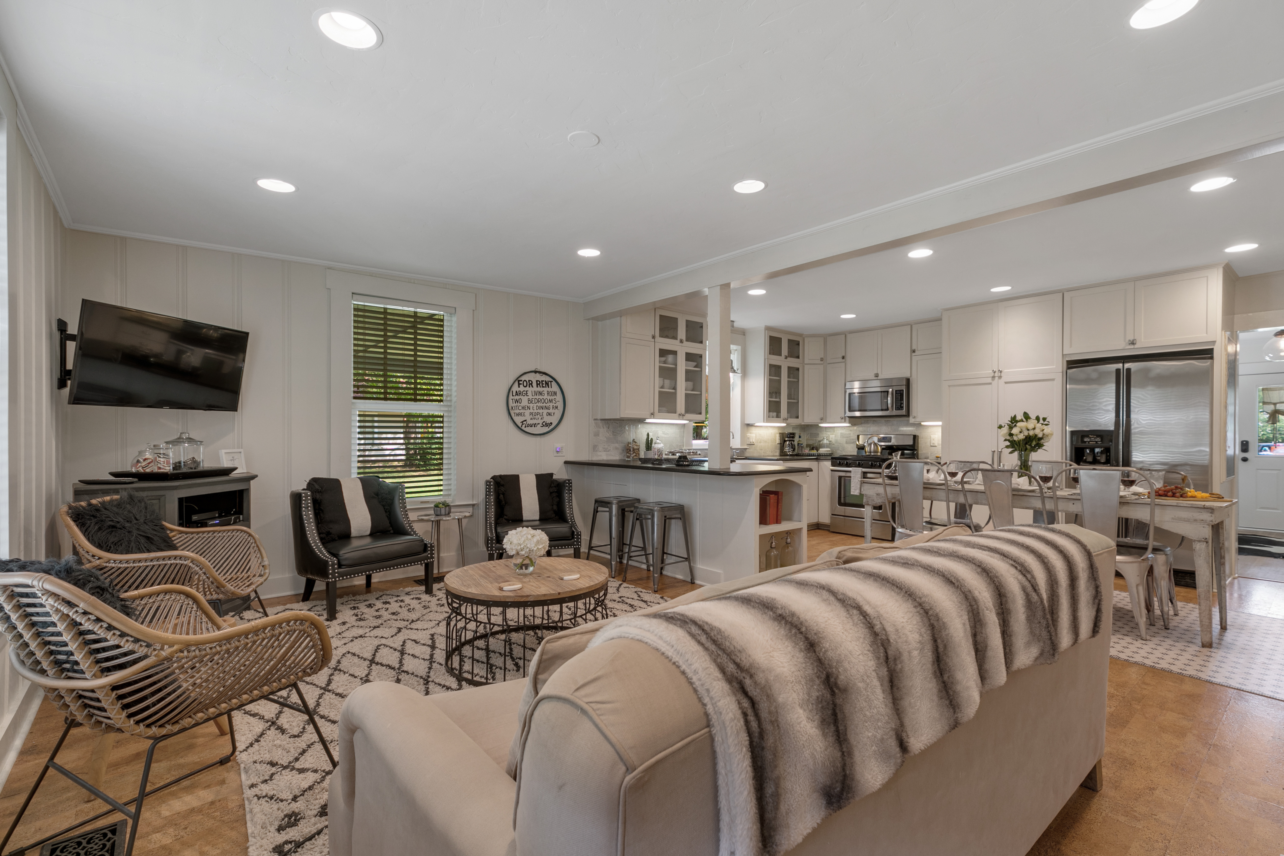 Clover Haus has an inviting open concept design, seamlessly connecting the living room, kitchen, and dining area for a spacious and communal feel.