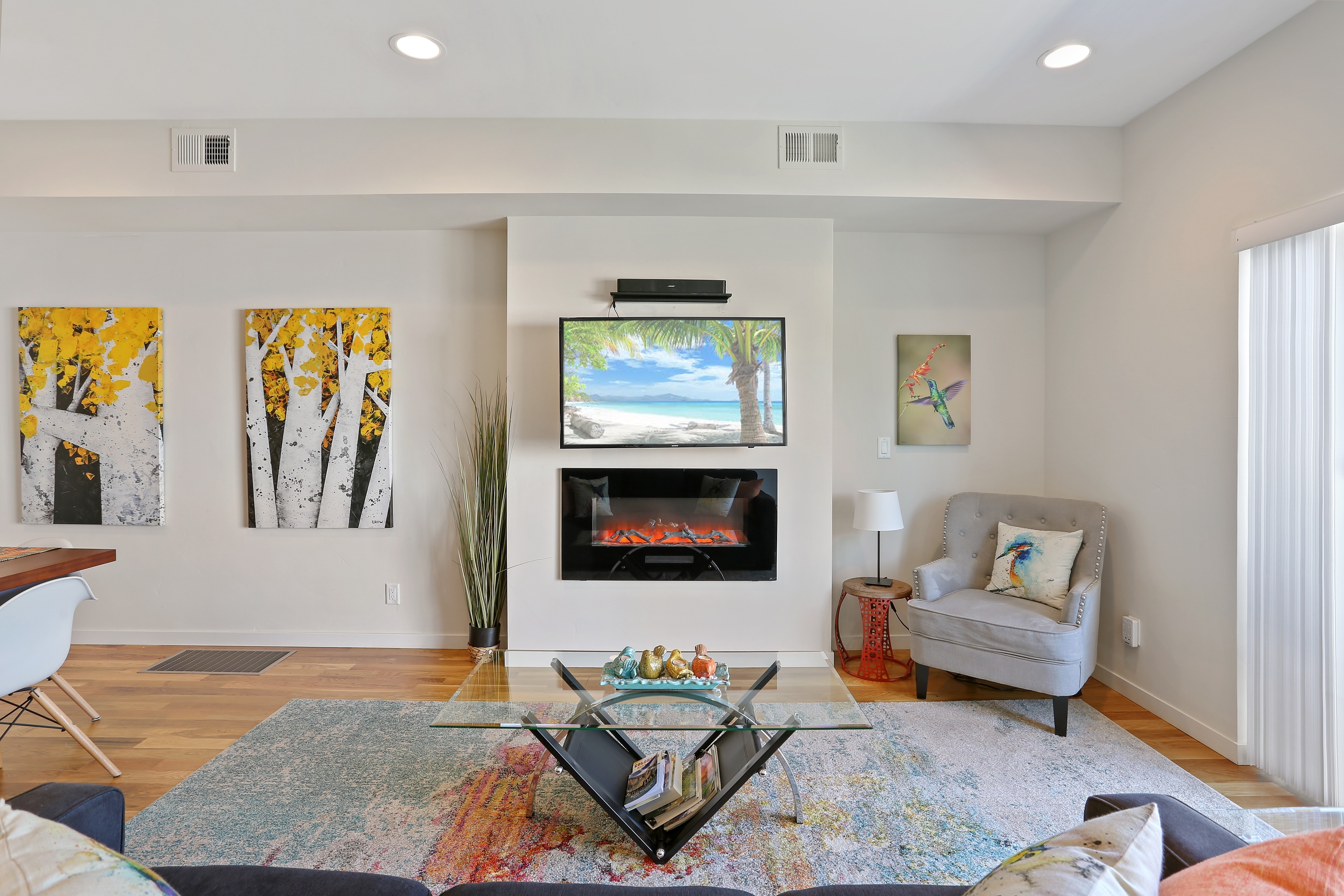 Living room with smart TV and electric fireplace.