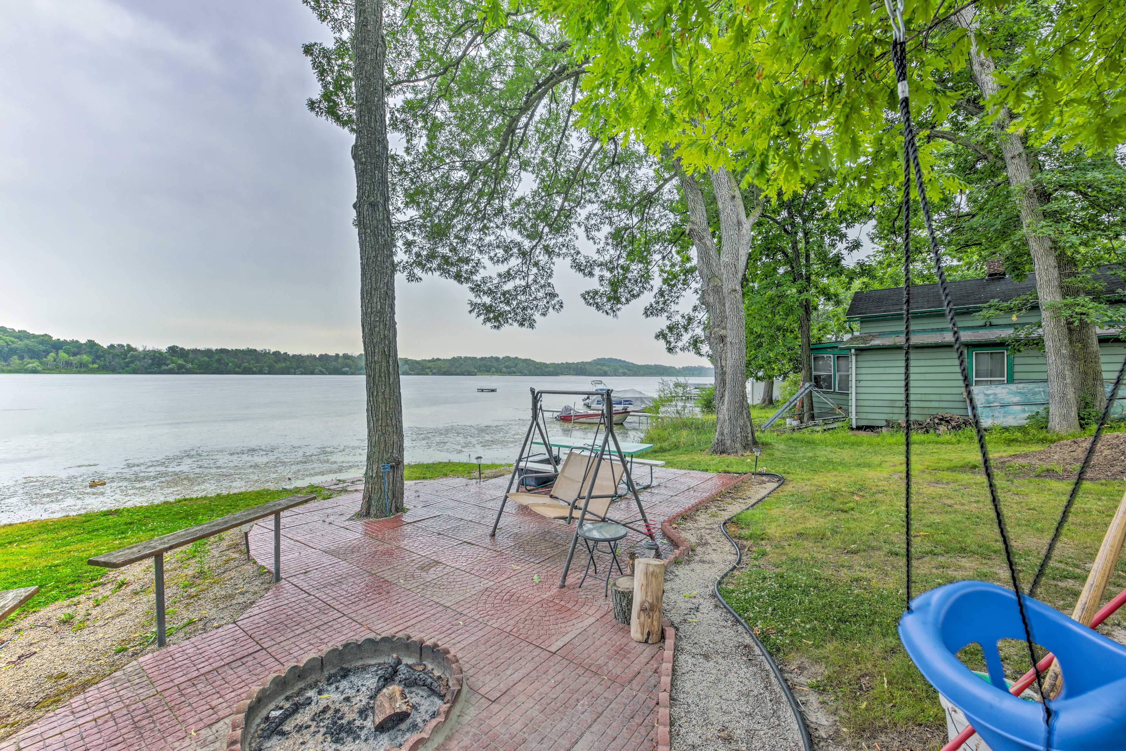Property Image 2 - Colorful Cottage w/ Porch - Steps to Long Lake!
