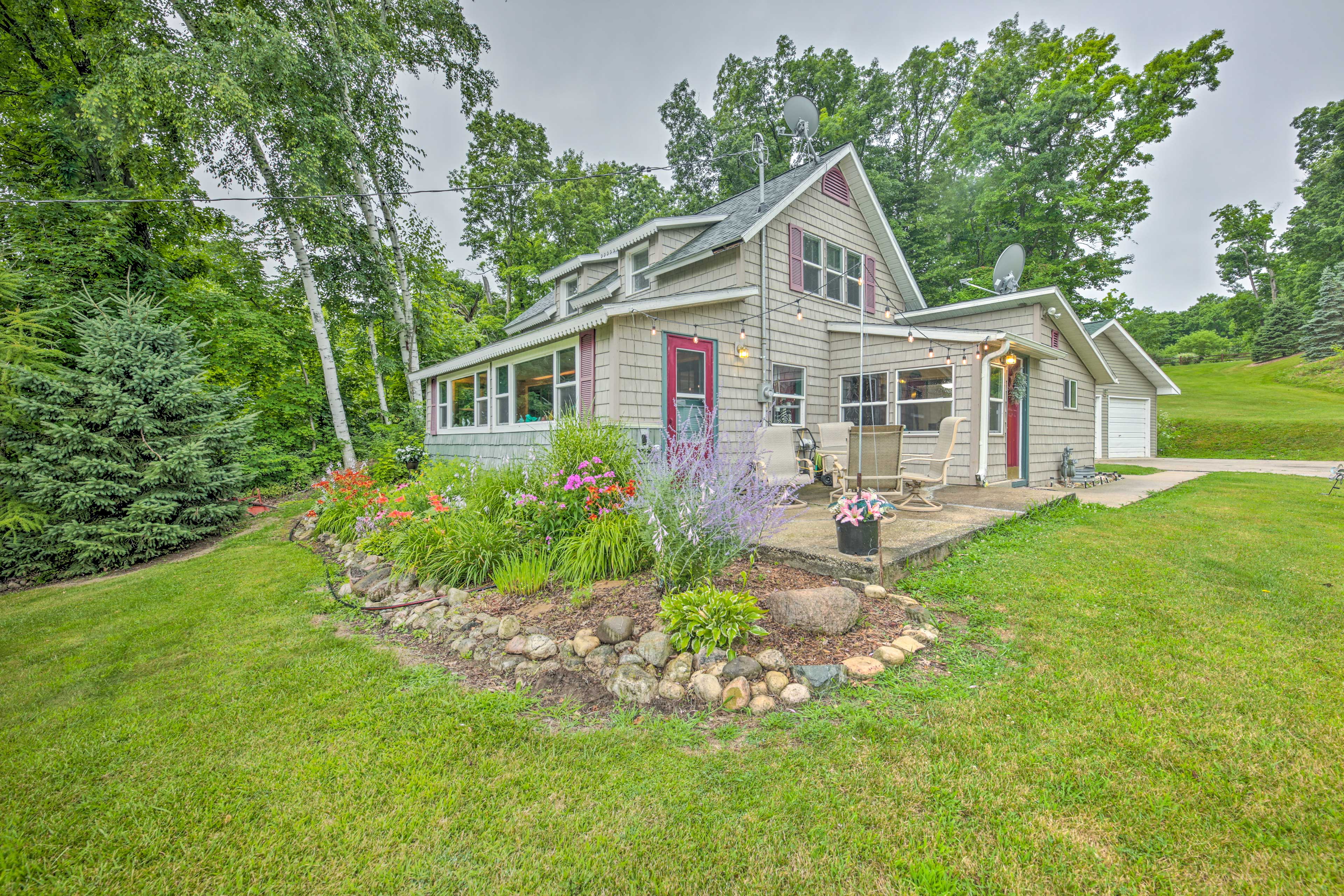 Property Image 1 - Colorful Cottage w/ Porch - Steps to Long Lake!