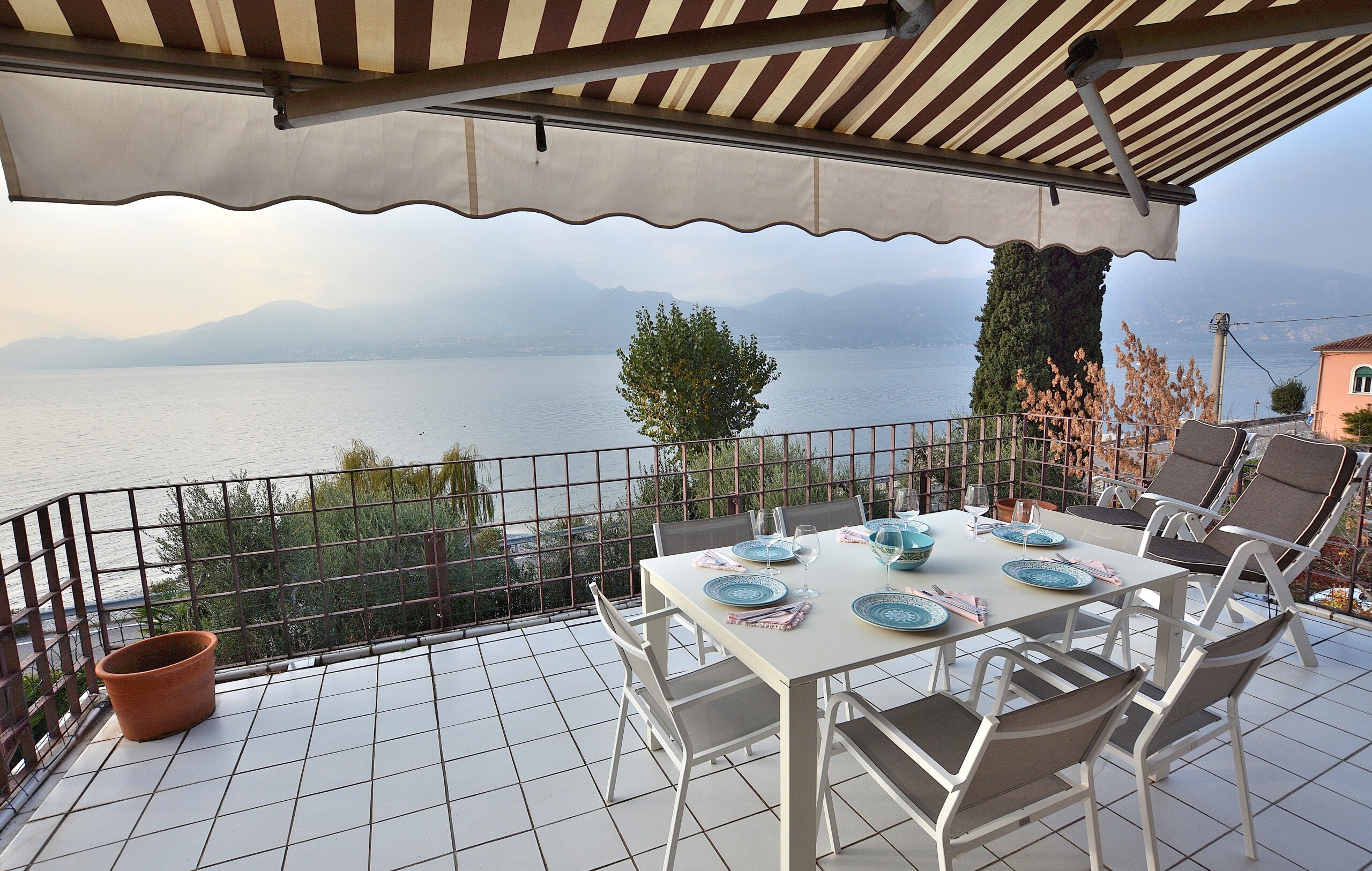 Terrace with table with BBQ and lake view