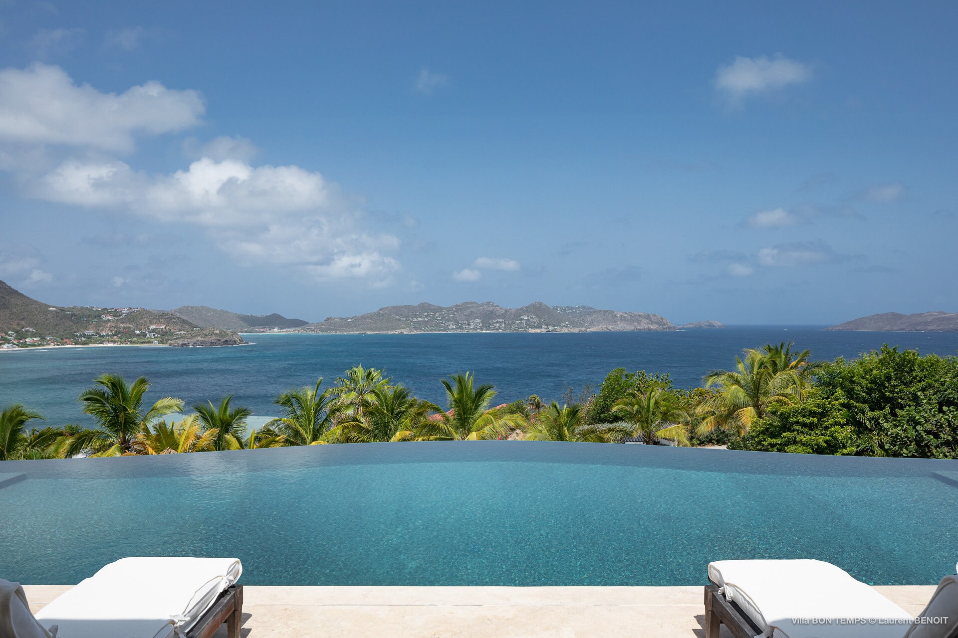 Infinity pool and large covered terrace that runs the length of the villa with dining and lounging areas.&nbsp;