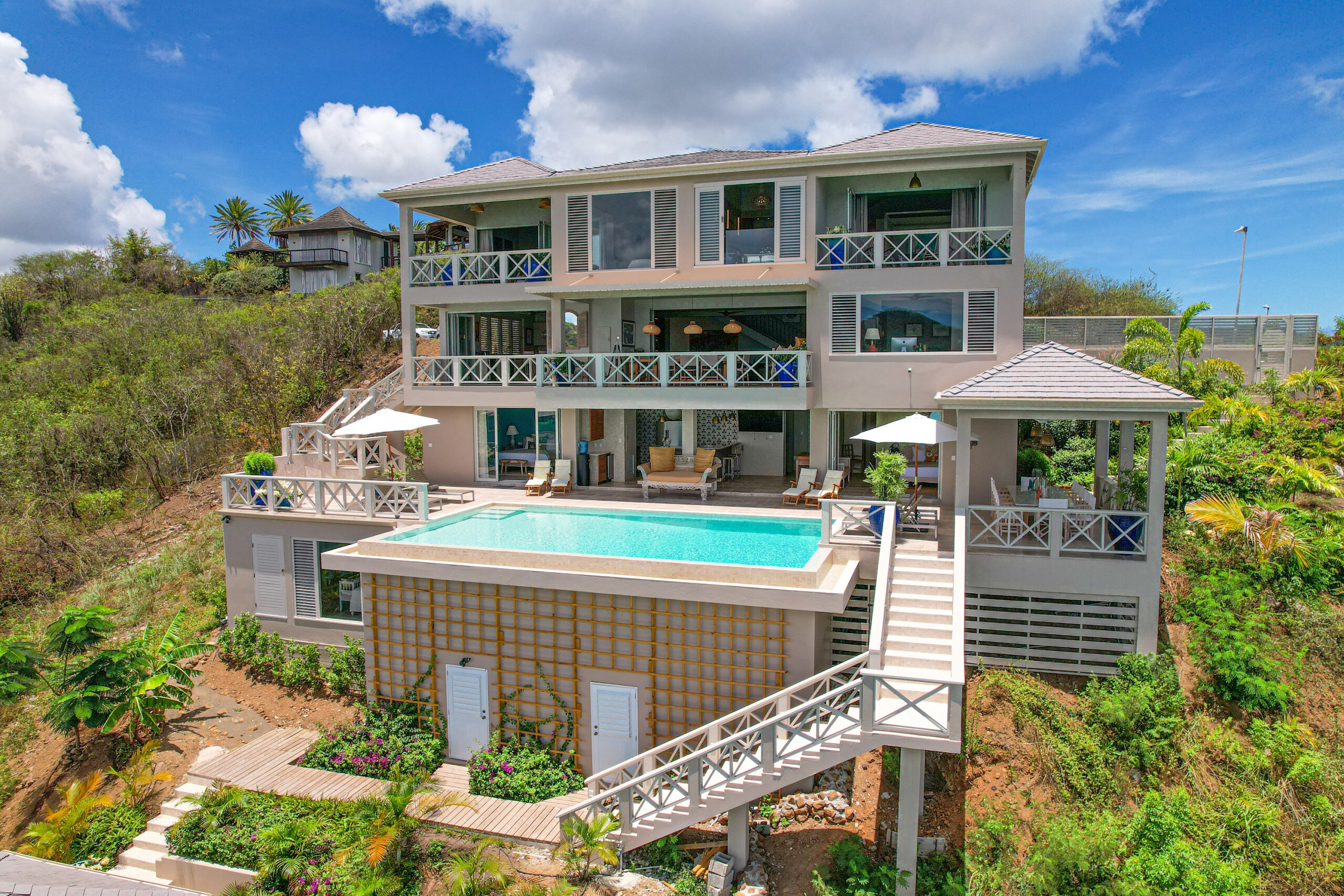 Exceptional Luxury Six Bedroom Estate House, with spectacular views, Private infinity pool, terraced garden, and Large dining area at Jolly Harbour Villa rentals.