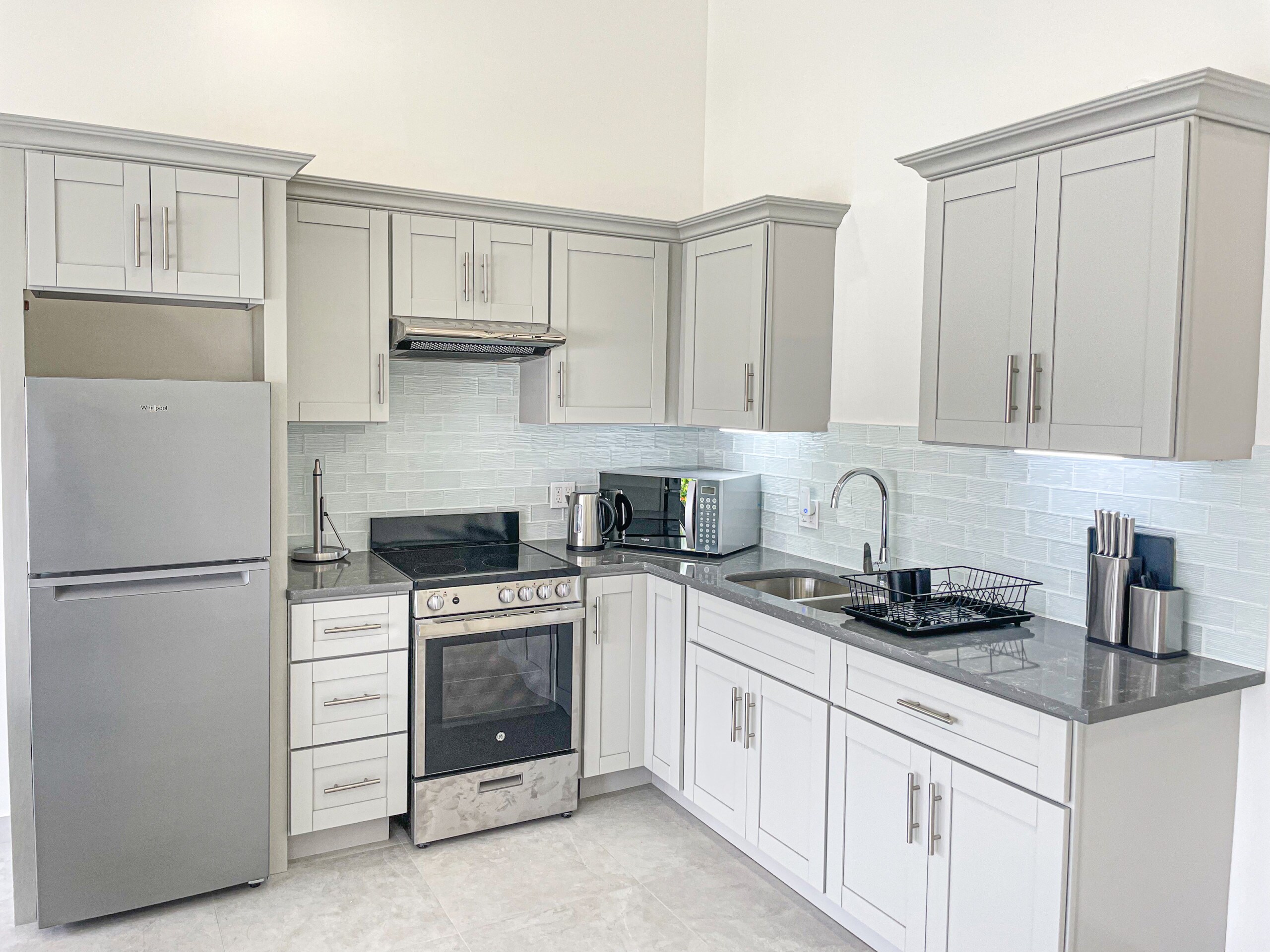 Stylish and Spacious One Bedroom Apartment with a simple, bright open kitchen with good cabinet space and modern appliances at Jolly Harbour Villa Rentals