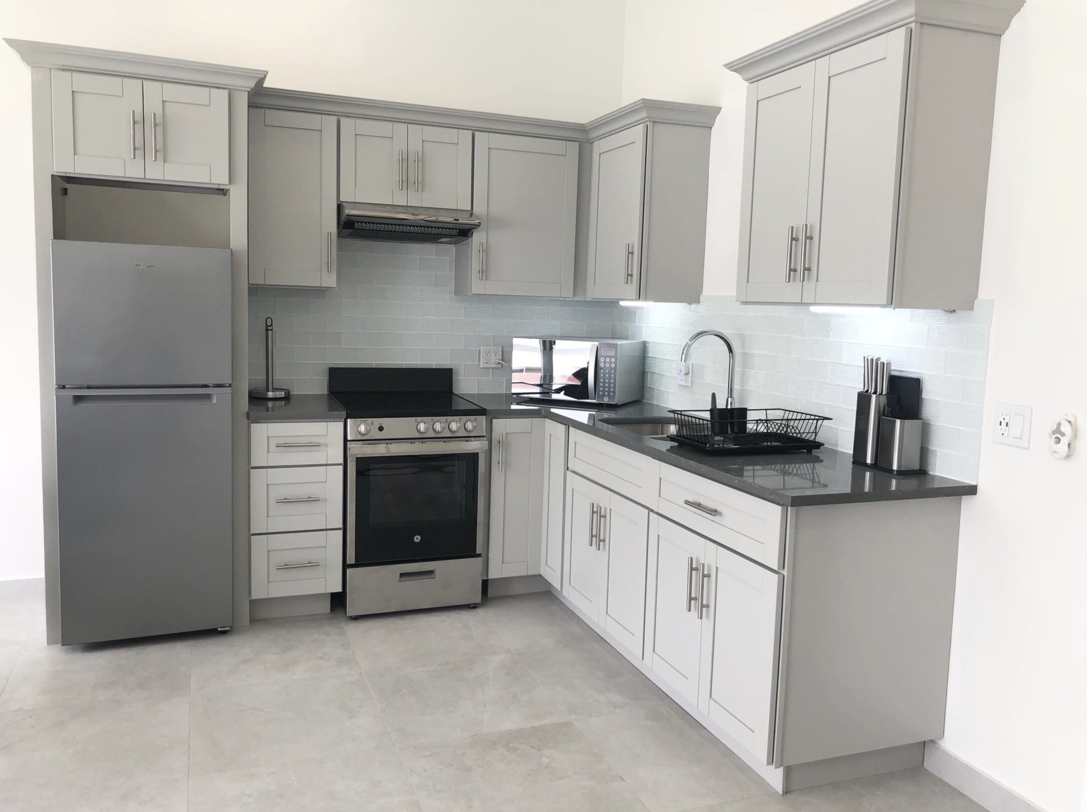 Modern One-Bedroom Apartment with a simple, bright open kitchen with good cabinet space and modern appliances at Jolly Harbour Villa rentals, Antigua 