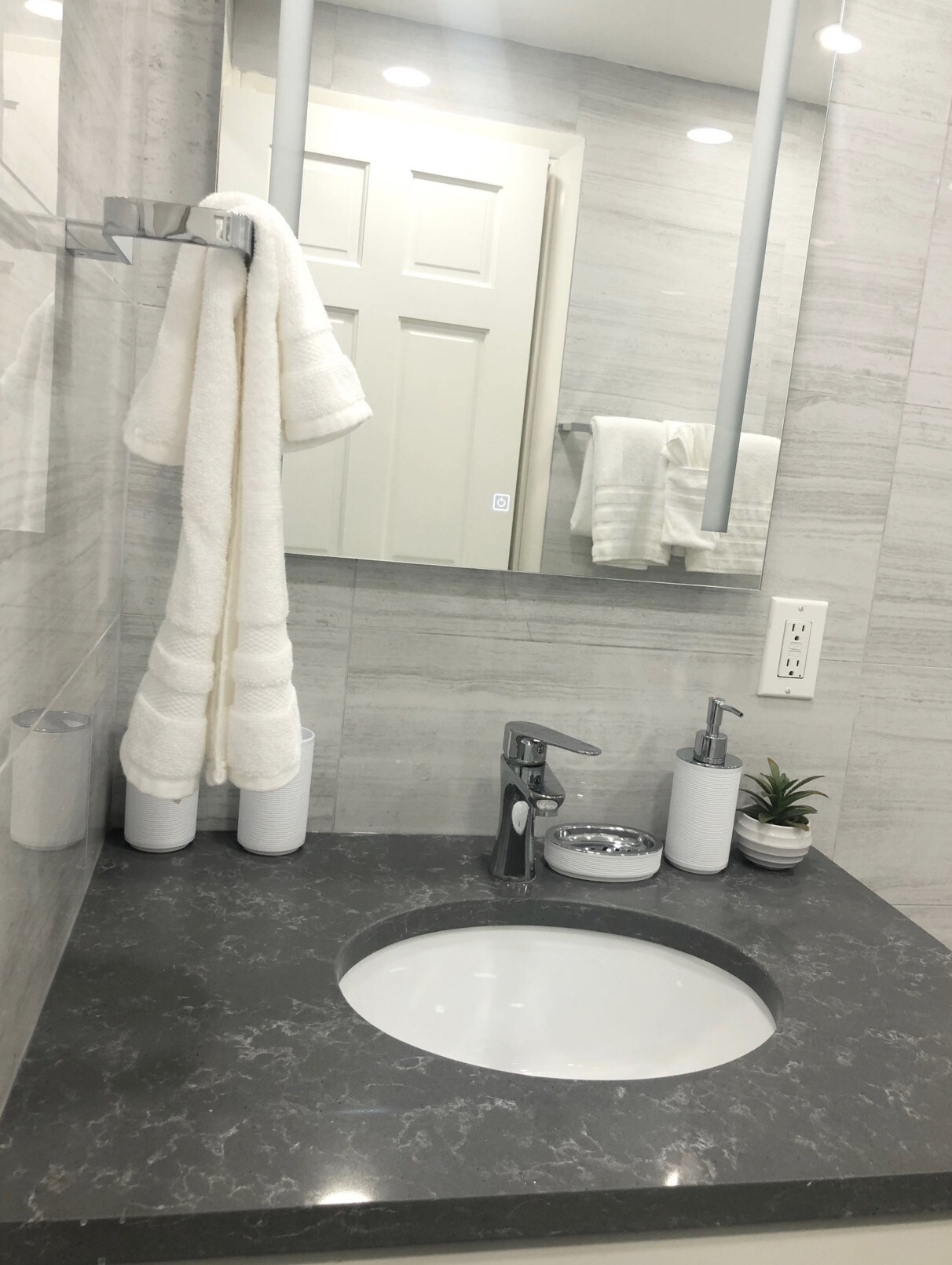Lovely One Bedroom Apartment, updated in modern shades of grey, black and white, fitted with a sink, mirror and large shower at Jolly Harbour Villa rentals