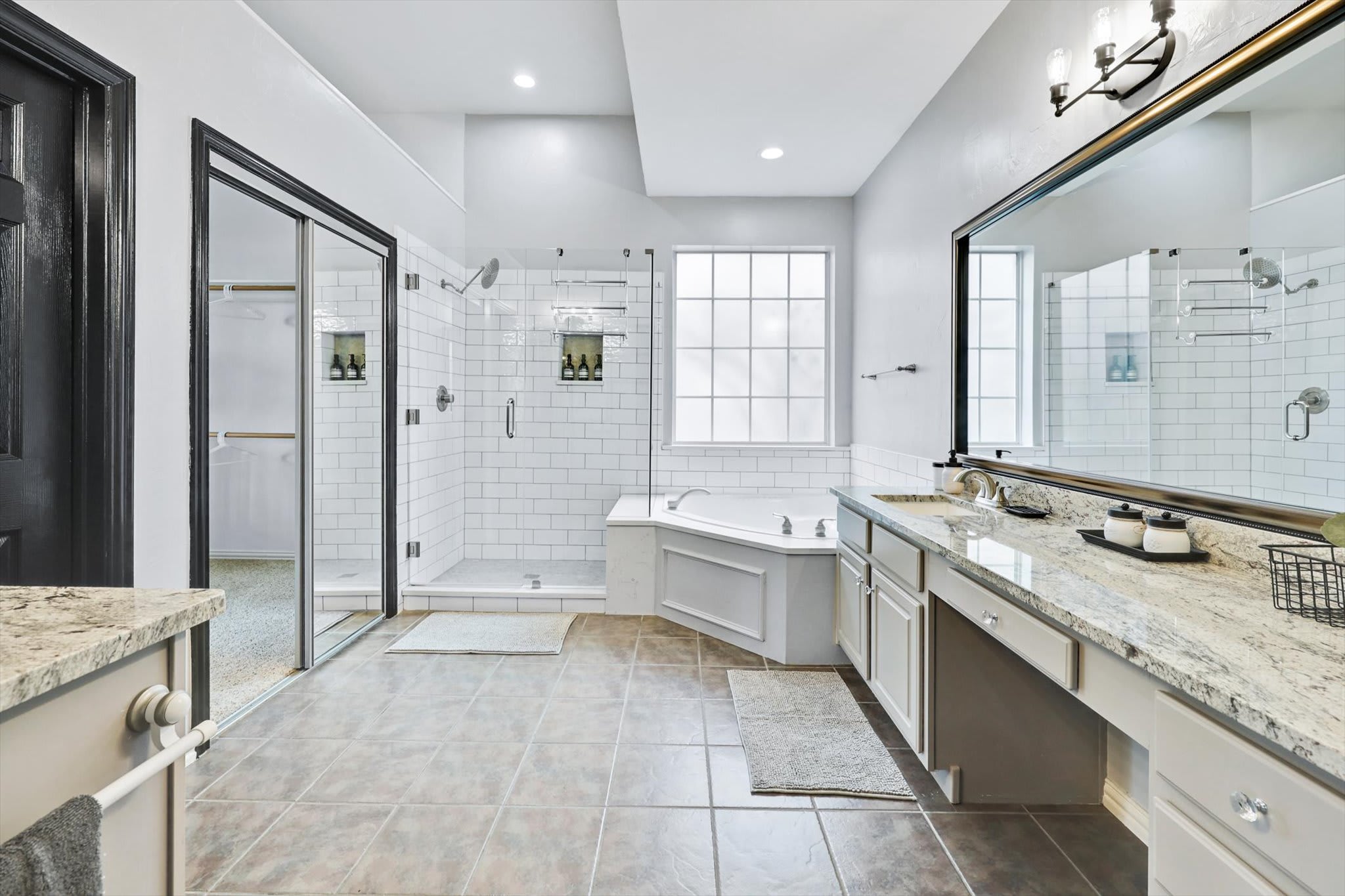 This bathroom was designed to give you a spa-like feel with its luxurious jetted tub, glass walk-in standing shower, and granite countertops!