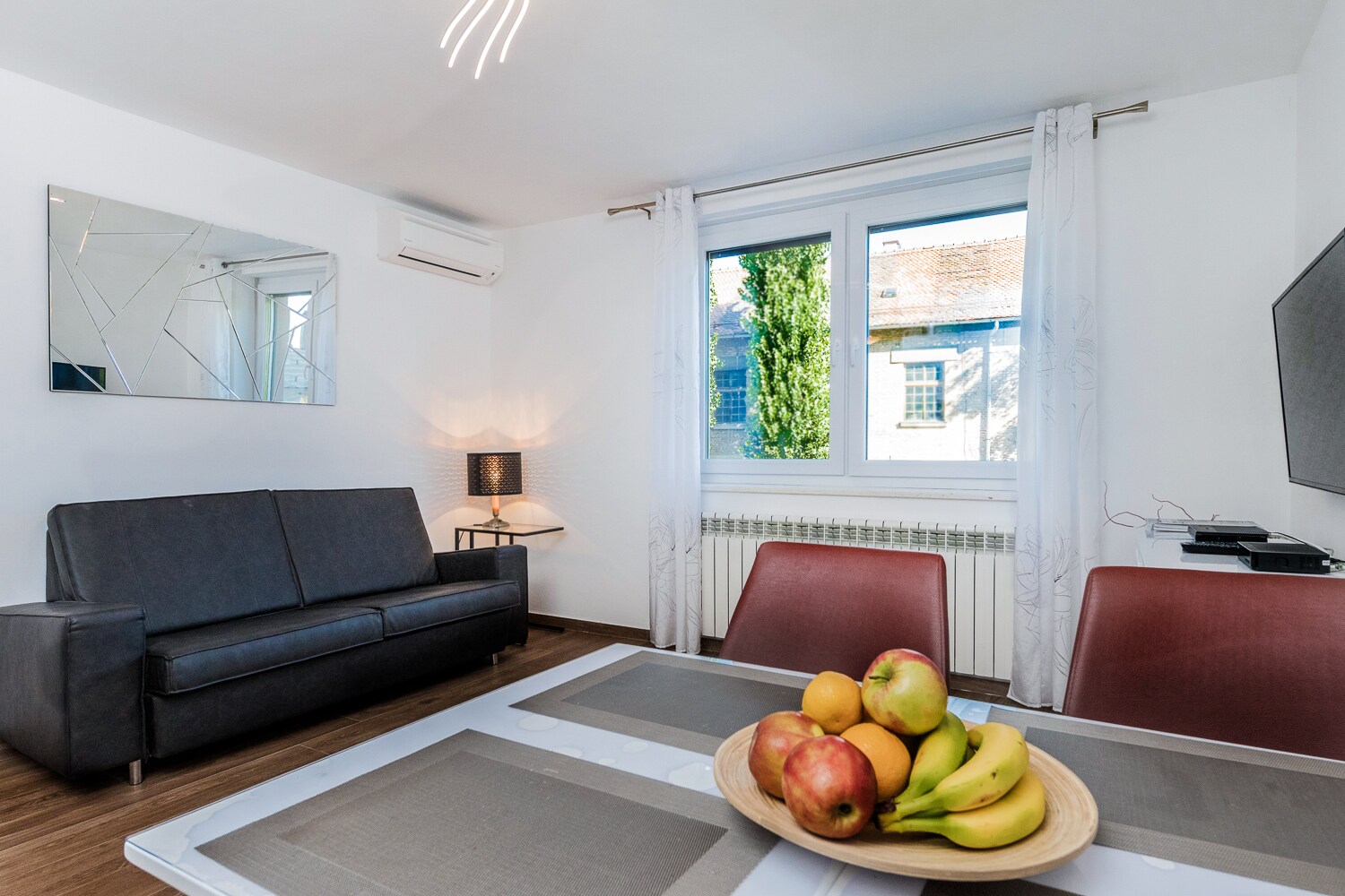 The bright living room with a comfortable sofa bed