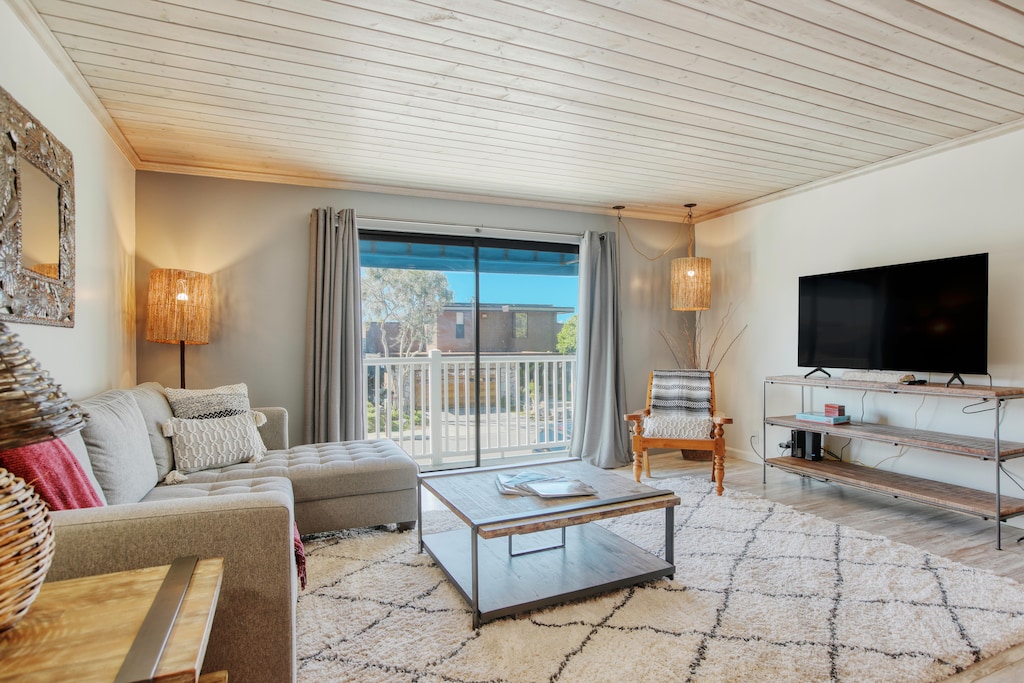 Spacious open living with balcony. Peek-a-boo ocean view from balcony.