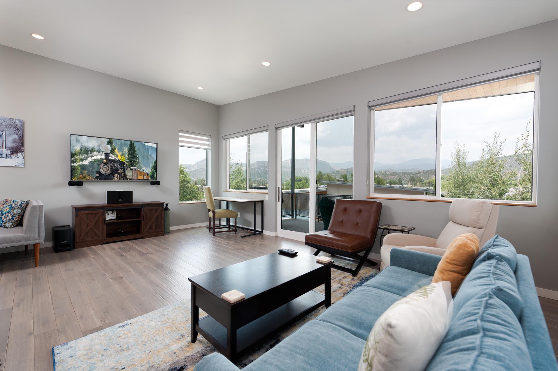 Durango, CO Vacation Rental Townhome

Living room with mountain views, large deck, and TV.