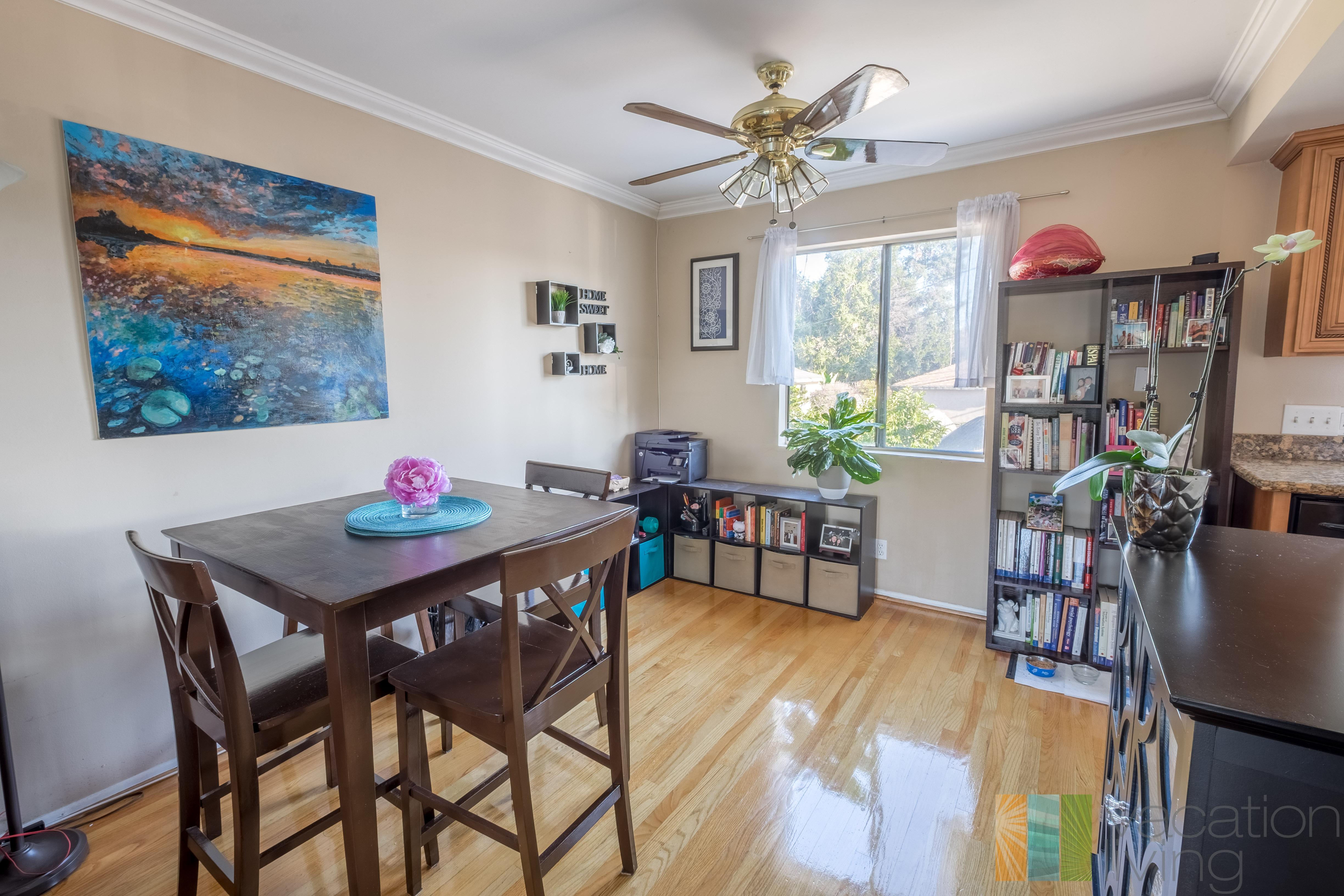 Clean and functional dining area past living room leading into kitchen.