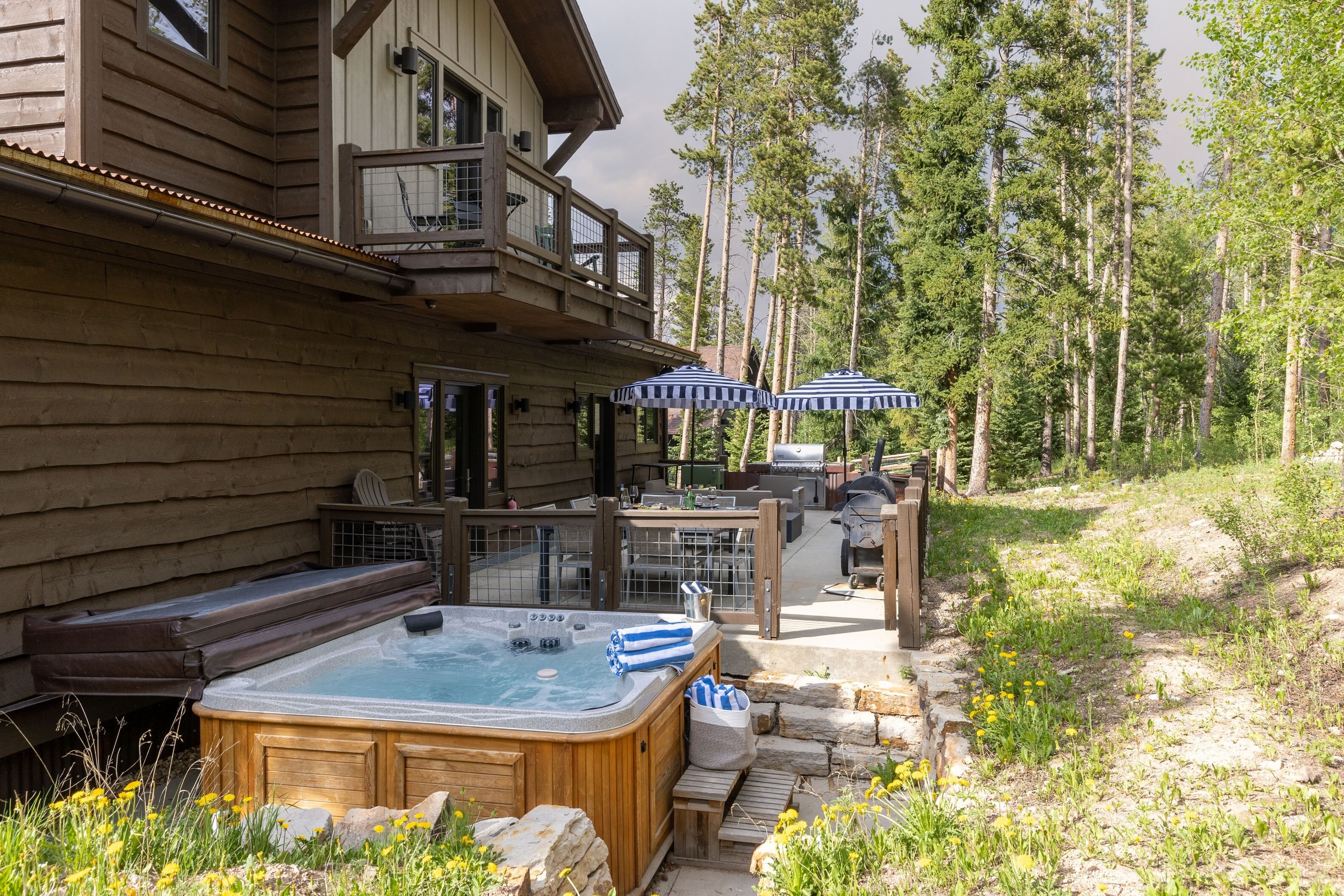 Deck with hot tub, grill, and lots of  outdoor seating and dining space.
