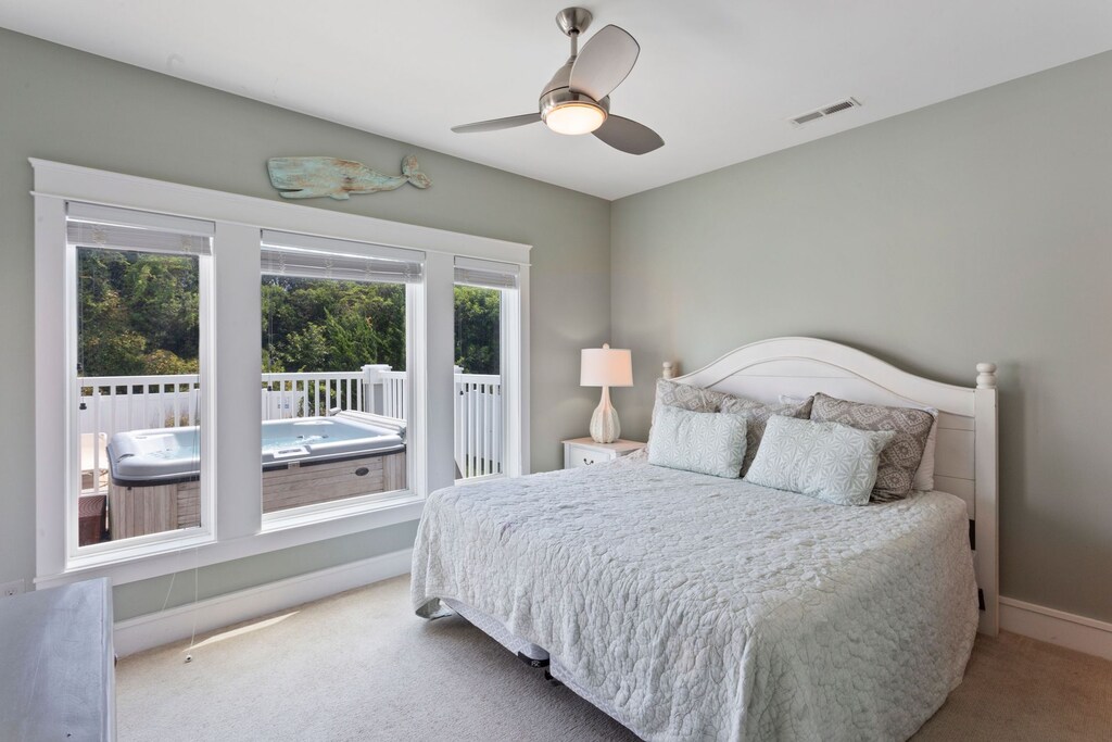 Head to the Lower-Level Master Bedroom for comfort, convenience, and views of the Outdoor Entertainment Area.