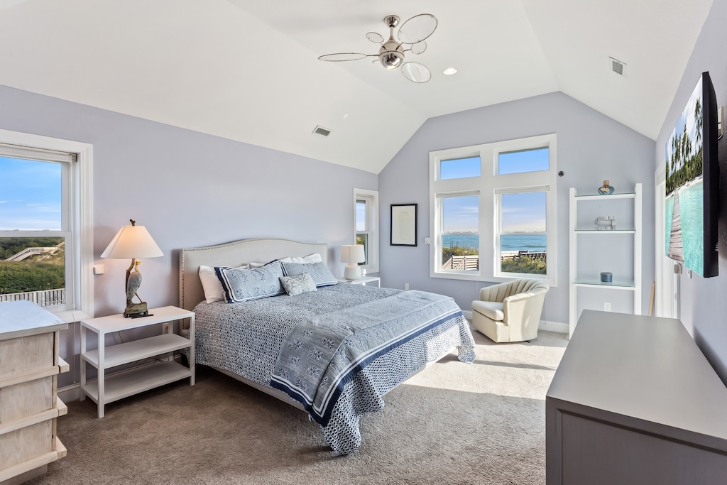 Get some rest in the King Master Suite with a TV, deck access, and a gorgeous ocean view.