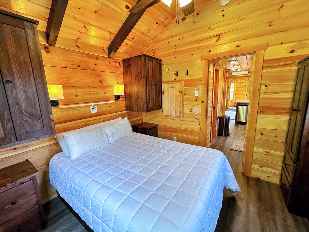 The main bedroom is past the kitchen and bathroom and has a queen bed.