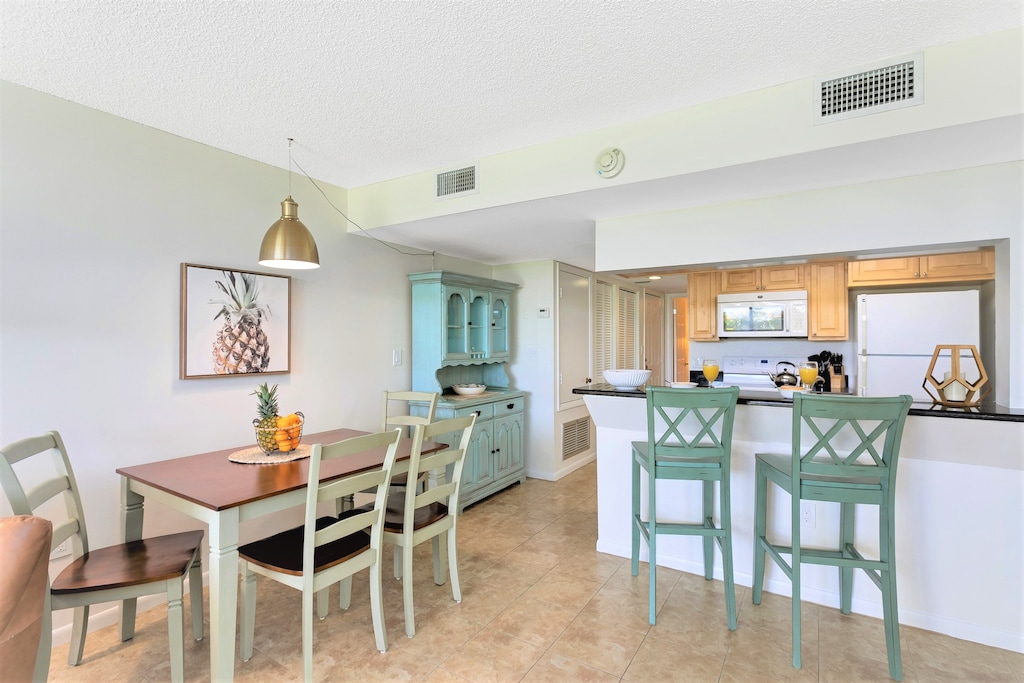 Gather around the dining table and enjoy meals in this bright open space