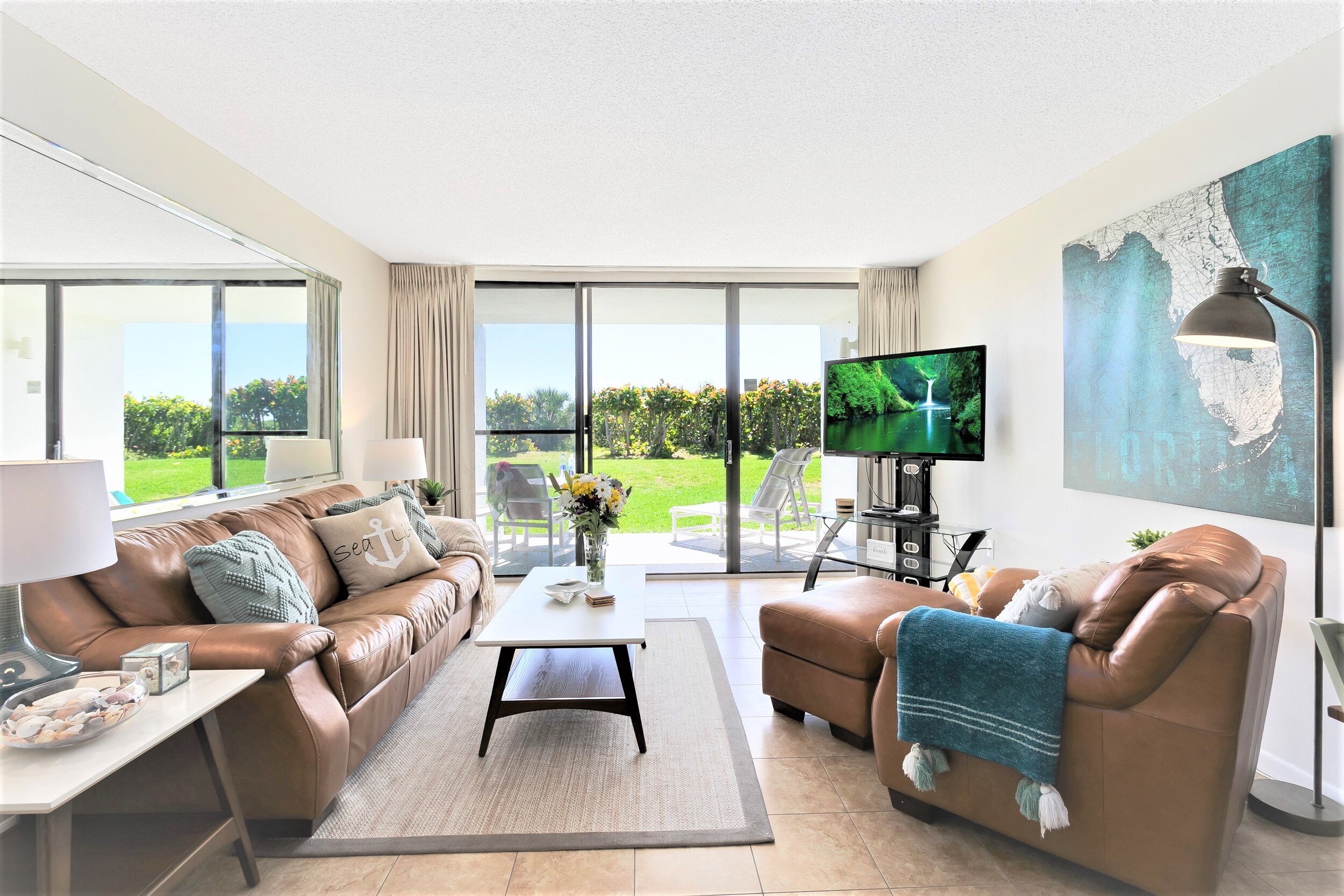 Living room with sleeper sofa and 55" LCD TV that walks out onto the patio facing the ocean