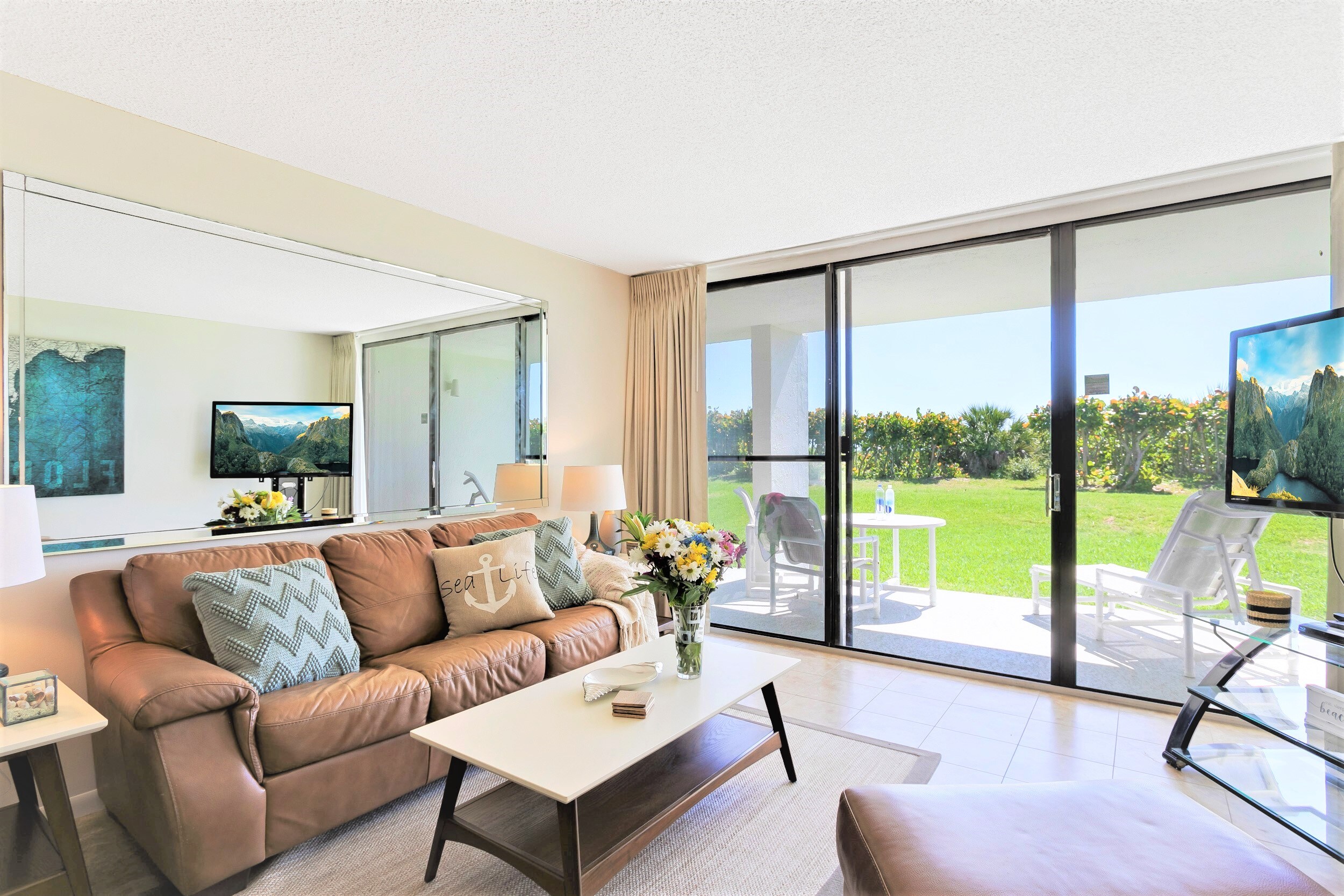 Living room with sleeper sofa and 55" LCD TV that walks out onto the patio facing the ocean