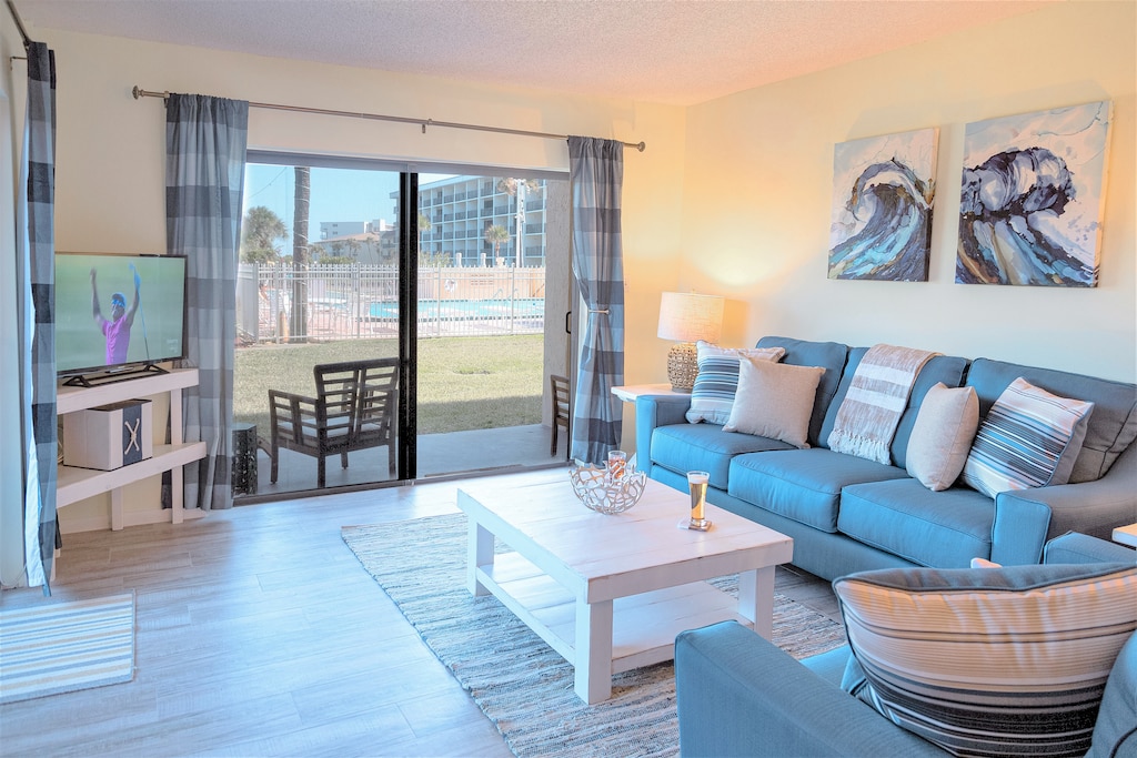 Closest Canaveral Tower condo to the ocean! Bright and modern living room with a coastal-inspired design.