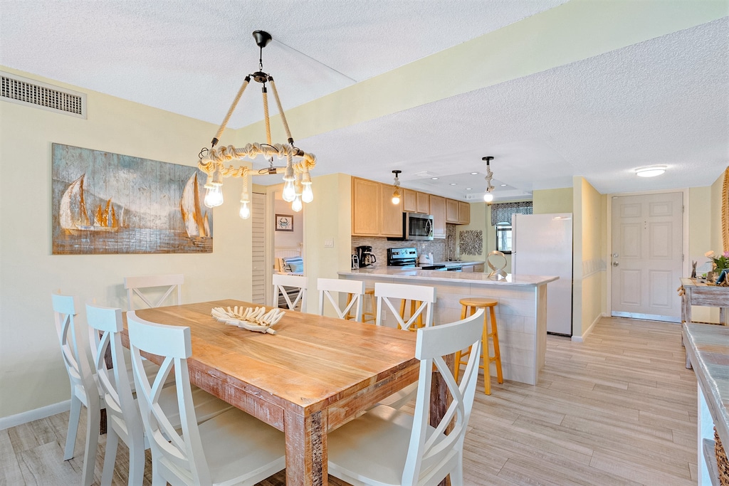 Elegant dining area seats eight with a modern chandelier