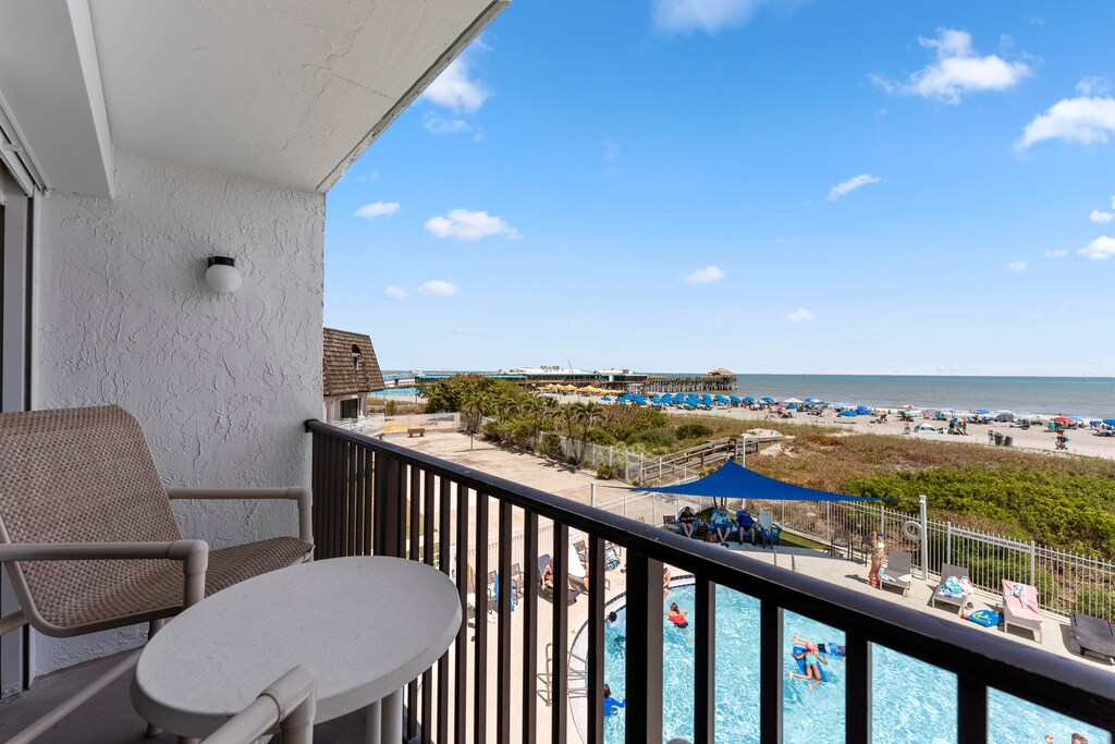 View from your balcony overlooking the ocean and pool