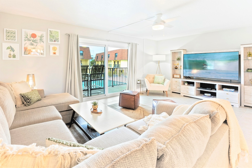 Relax in this huge living room, complete with a comfy wraparound couch, huge entertainment center and a view over the pool!