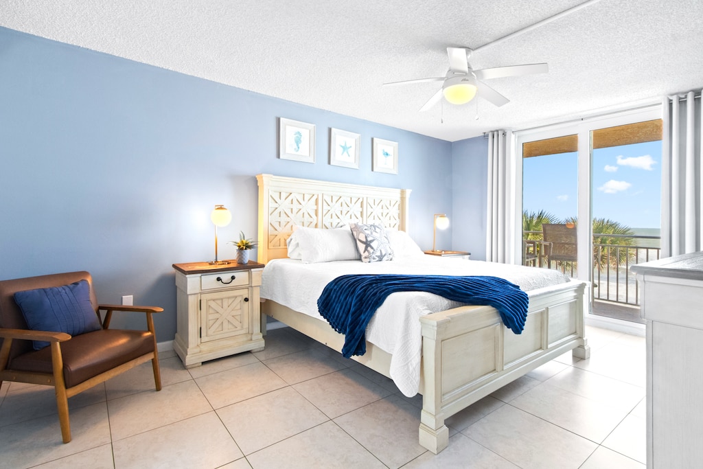 Master bedroom with a king-size bed, and direct access to a private ocean-view balcony.