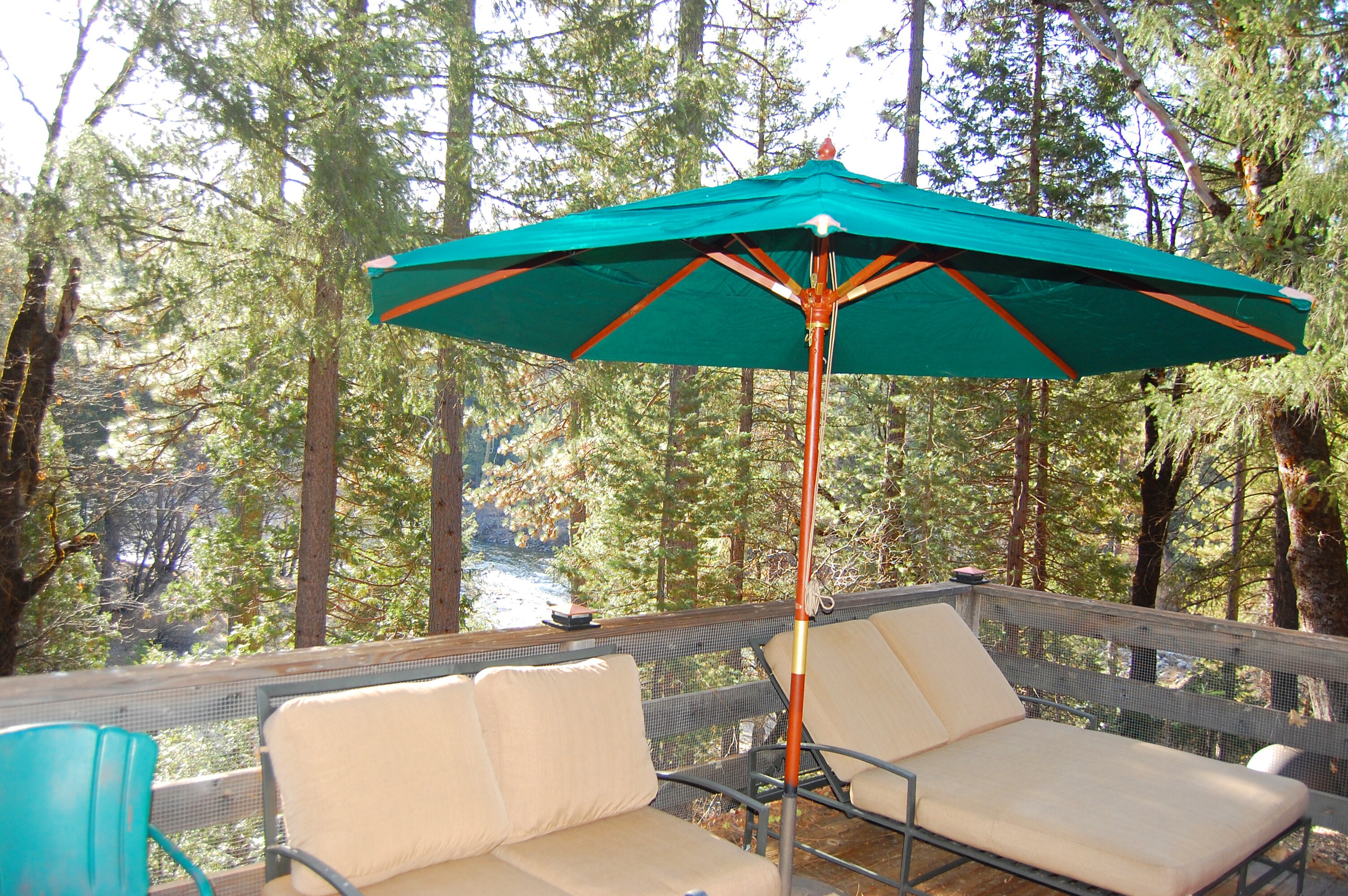 Relax in the double lounge under an umbrella listening to the flow of the South Fork of the Merced River (in background)