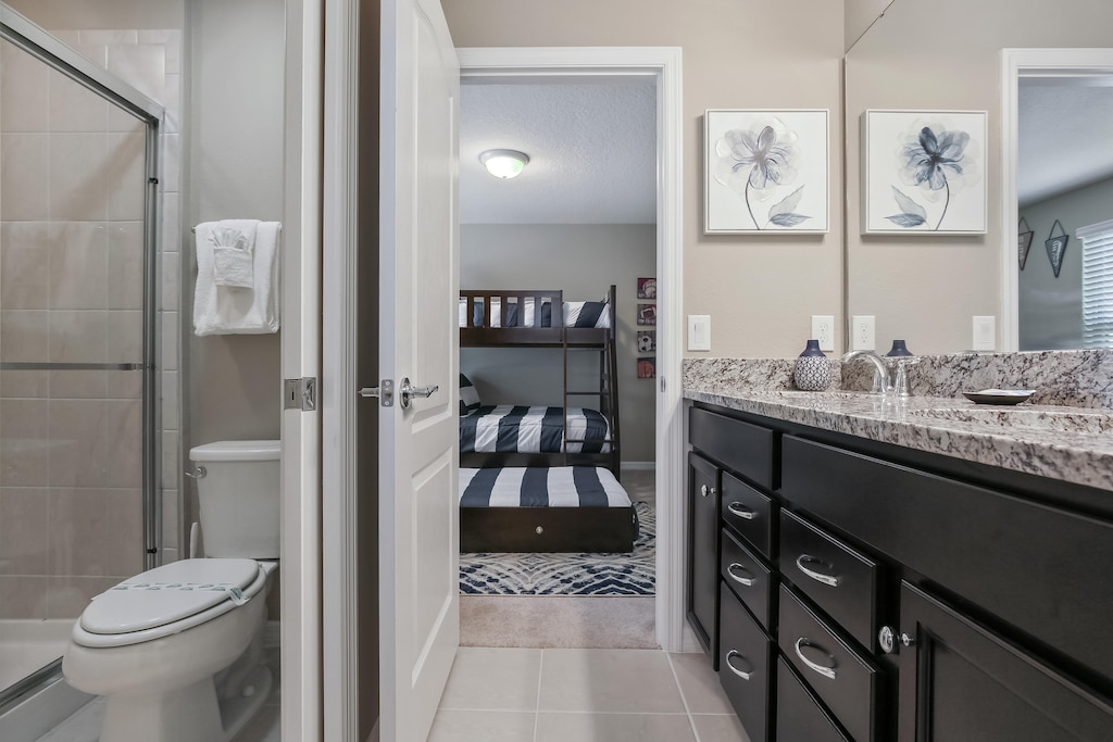 Fantastic double sink vanity with glass shower and toilet
