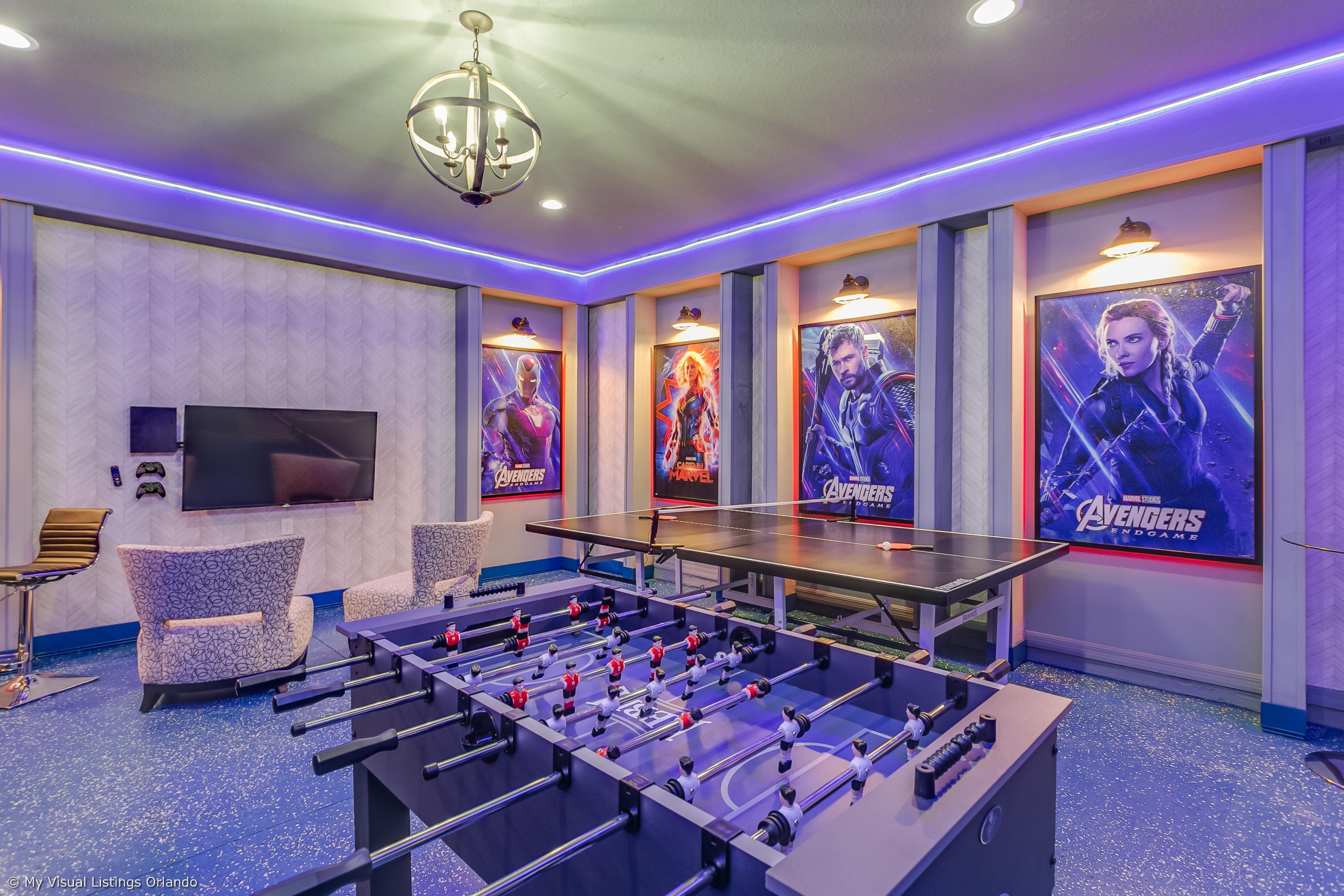 Amazing arcade room with game consoles, foosball, ping pong table, and air hockey
