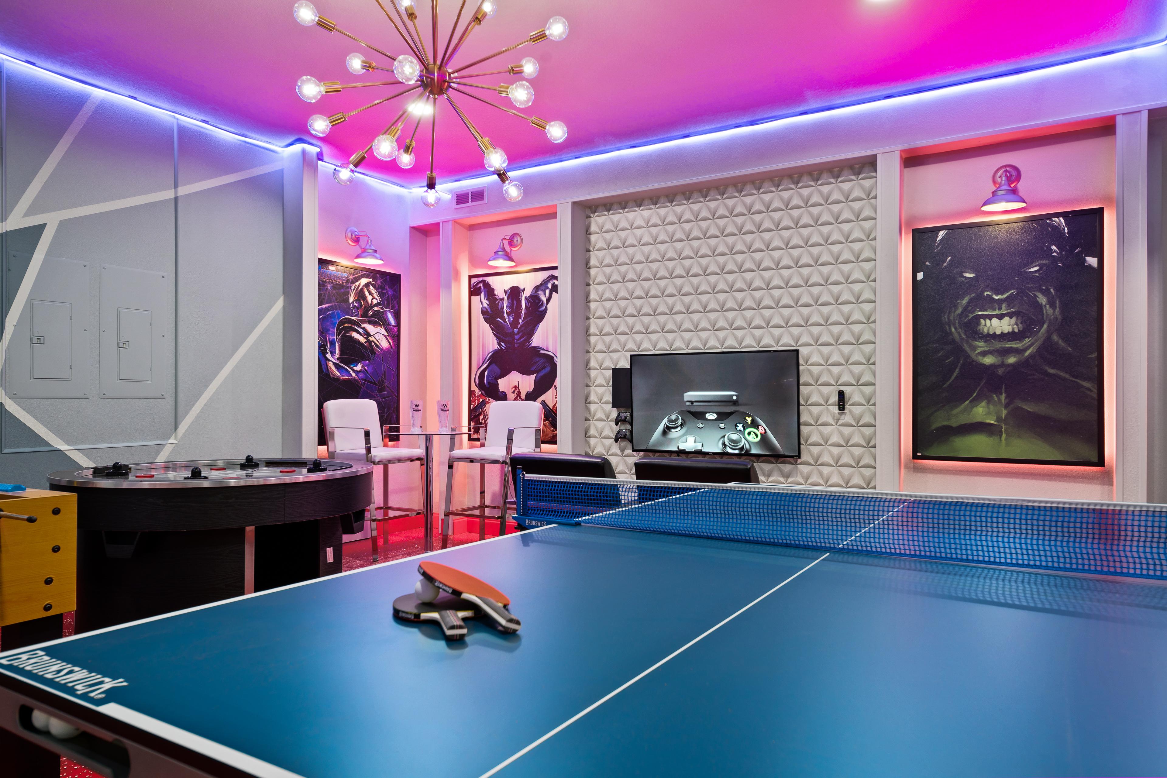 Amazing Marvel themed game room with ping pong, air hockey, and flat screen TV
