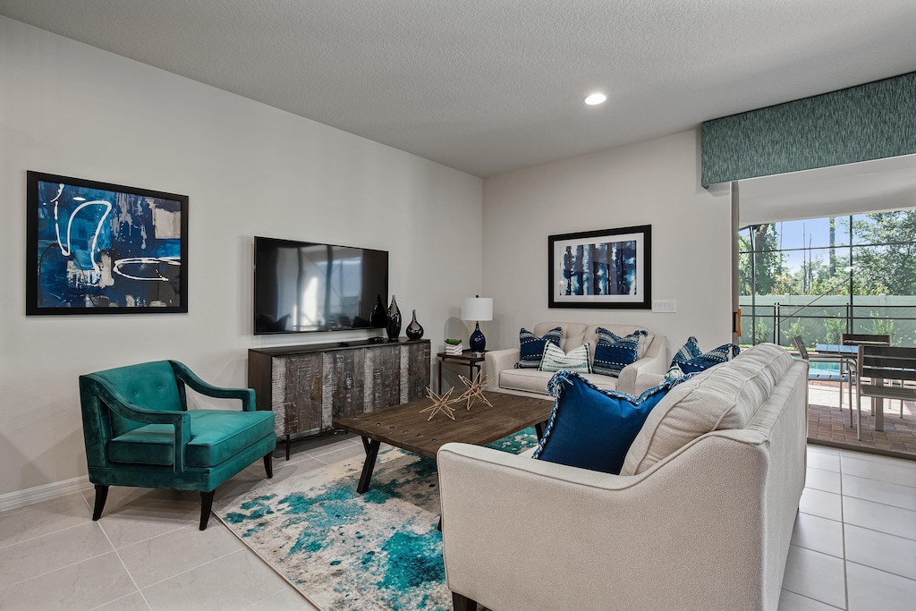 View 2 of comfortable living room area with flat screen TV
