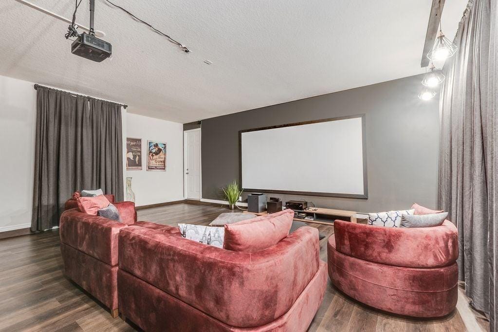 Lovely theatre room with comfortable seating and large projector screen