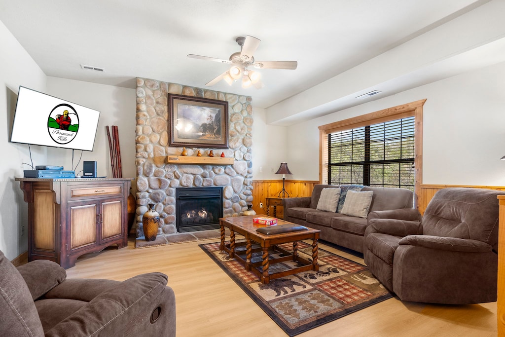 Relax in comfort in this cozy living room, complete with a beautiful stone fireplace