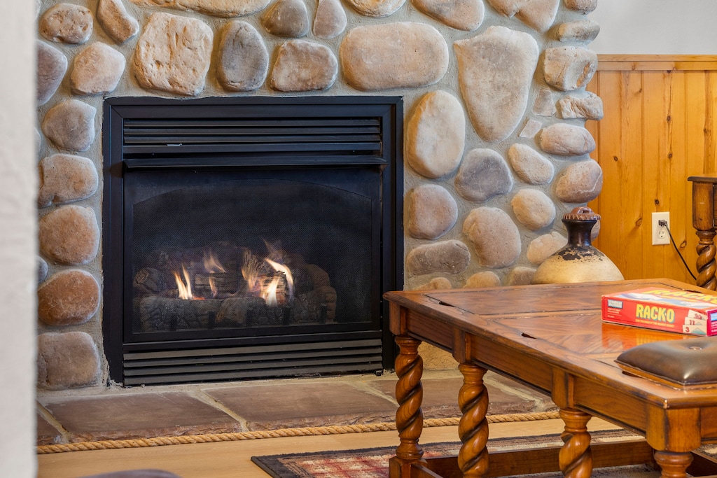 Curl up by the stone fireplace for a warm, relaxing evening indoors—perfect after a day of exploring Branson