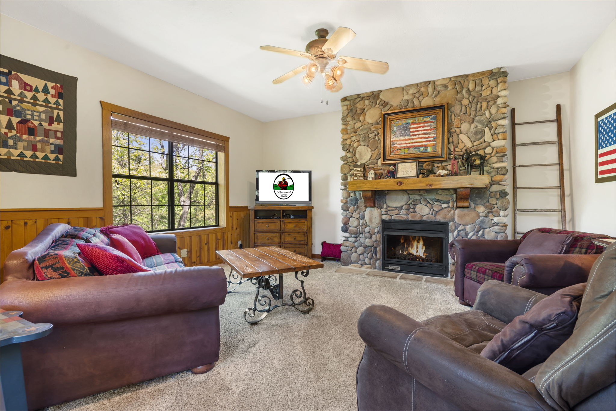 Living Room featuring Cable TV, Sofa Bed and a Seasonal Gas Fireplace