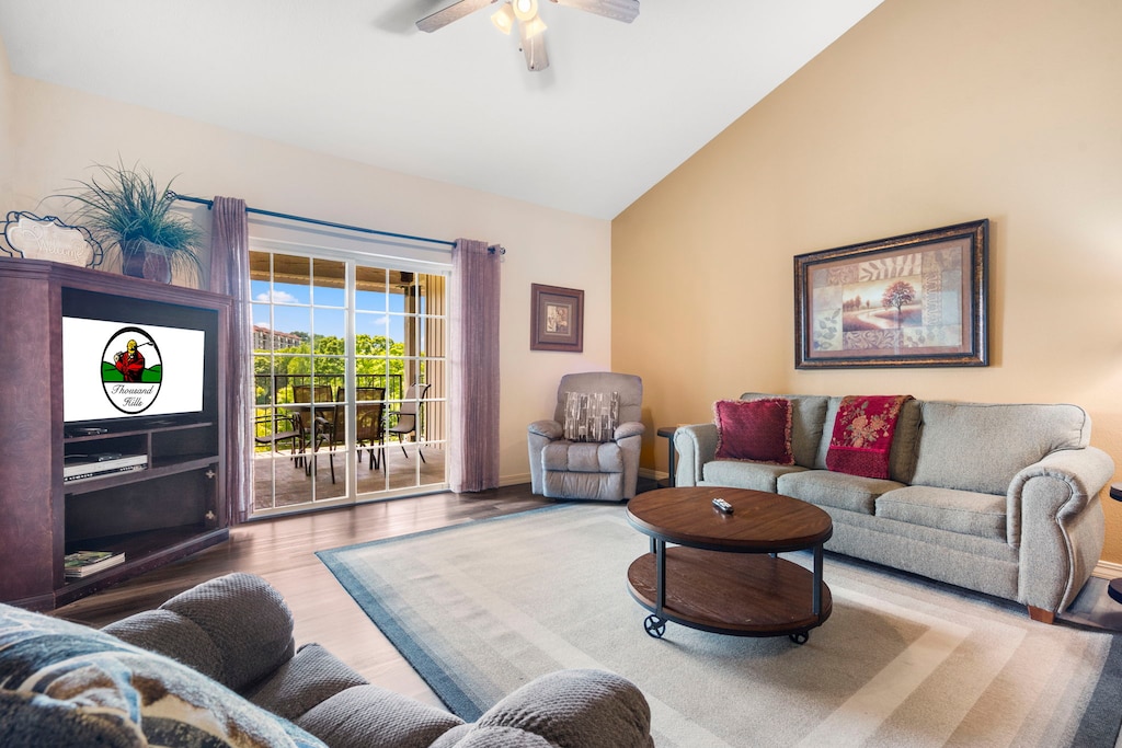 The living area is spacious and features cable TV, 2 recliners, a queen-sized sofa sleeper, and access to the deck