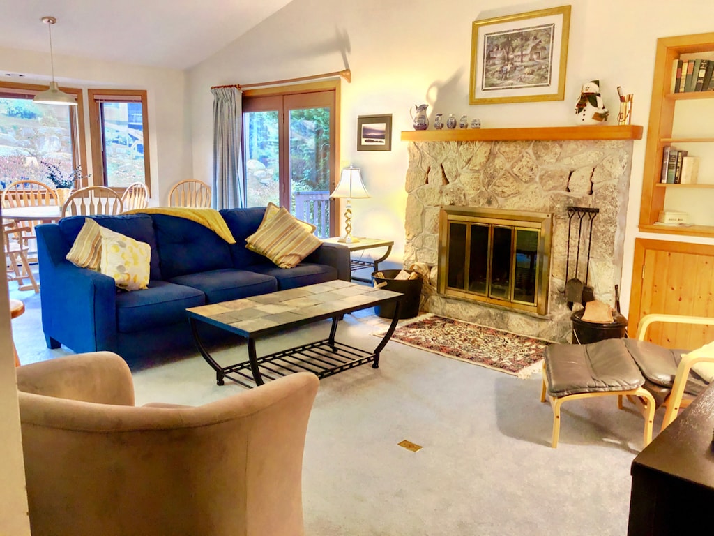 Dining/Living Area: Open concept space with cozy dining table that seats 4 and comfortable furniture that surrounds the stone fireplace.