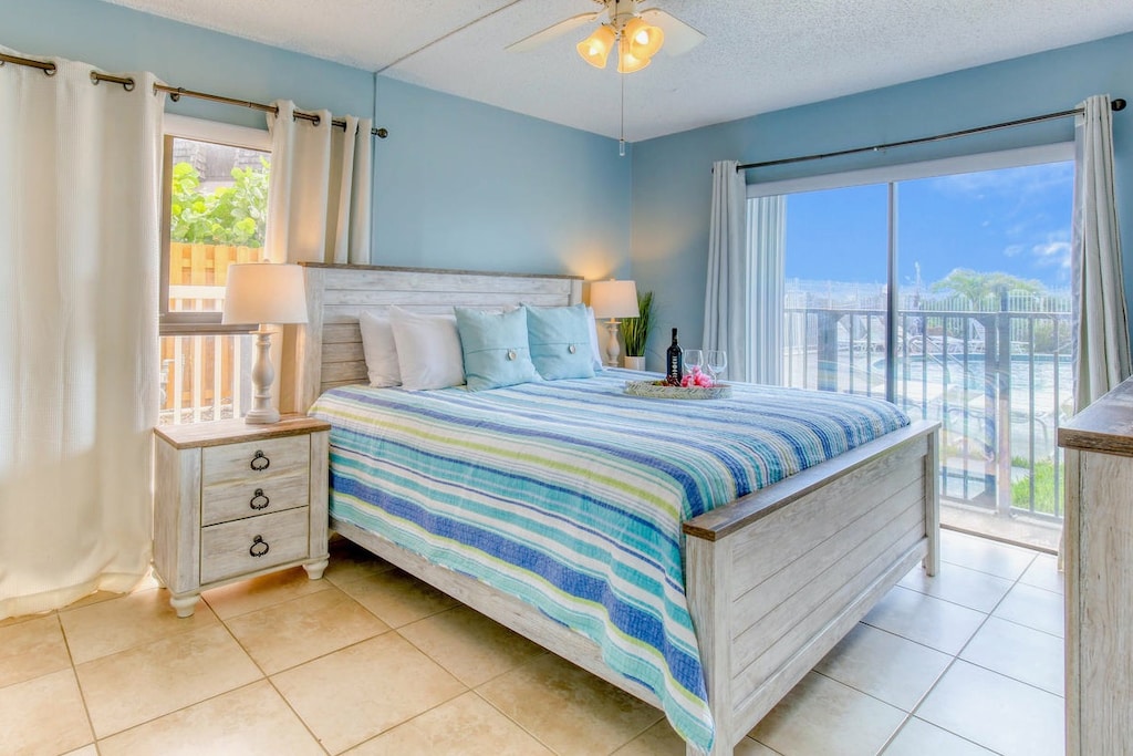 Cozy and stylish master bedroom with king size bed, TV and balcony access for a refreshing stay.